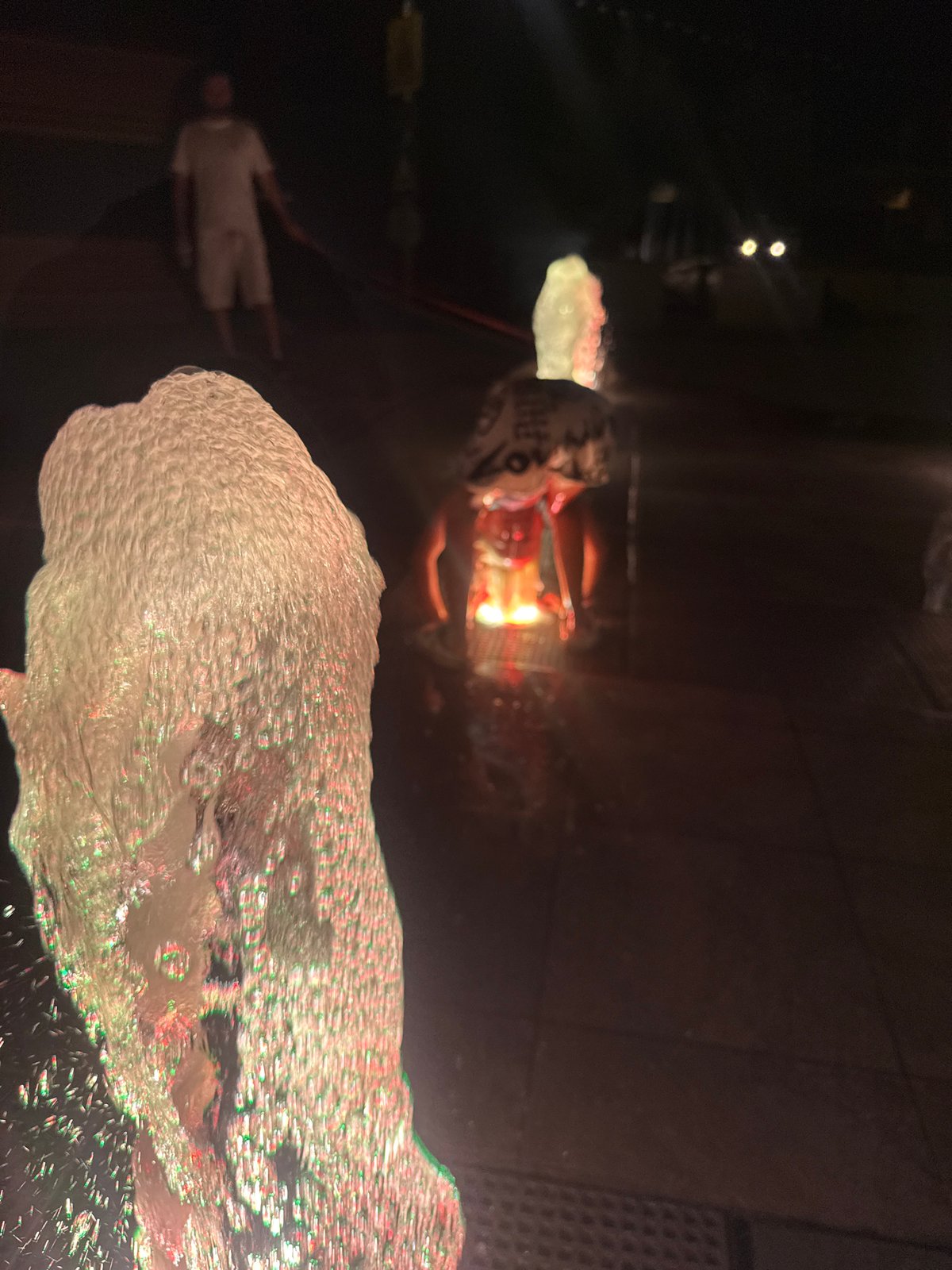 Summer night at a lit fountain plaza in Partenit, Ukraine