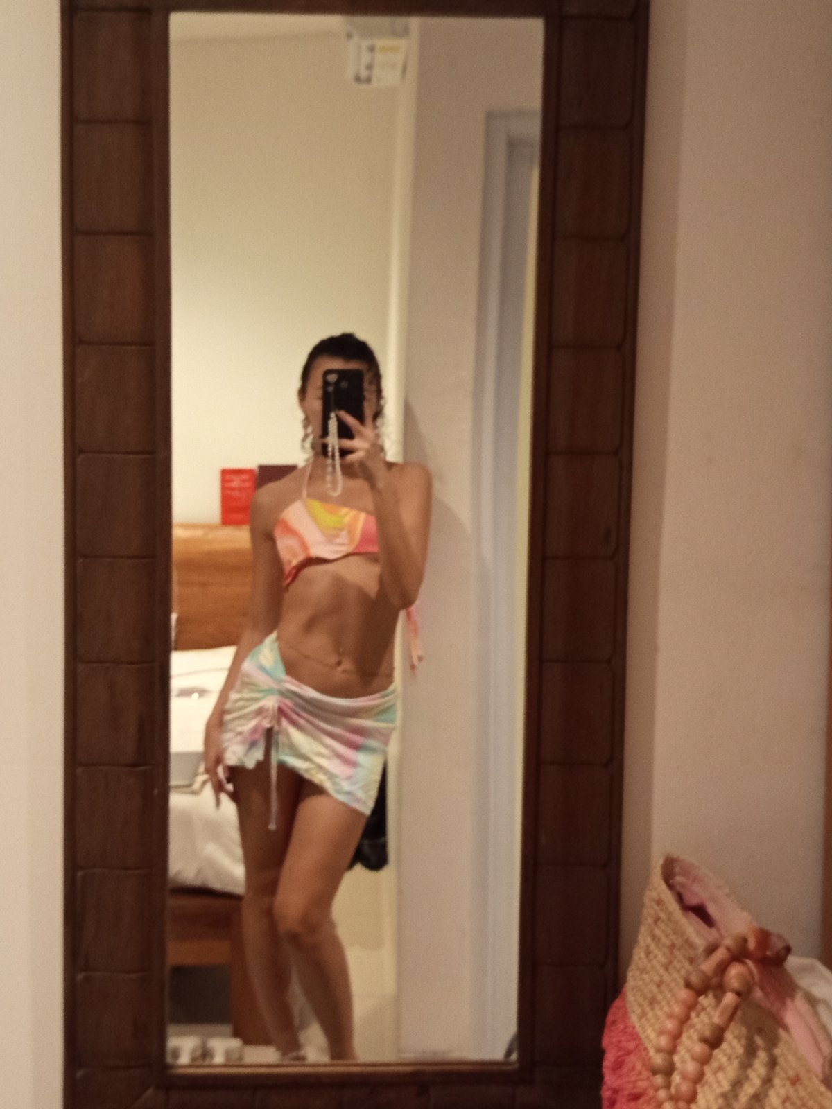 Woman takes mirror selfies in colorful outfit in North Kuta