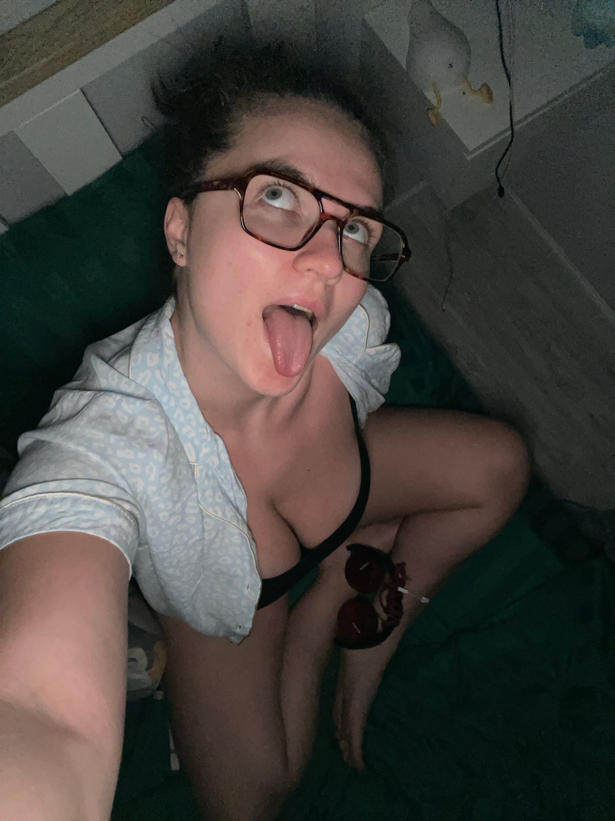 Woman with glasses observed in dimly lit Russian room