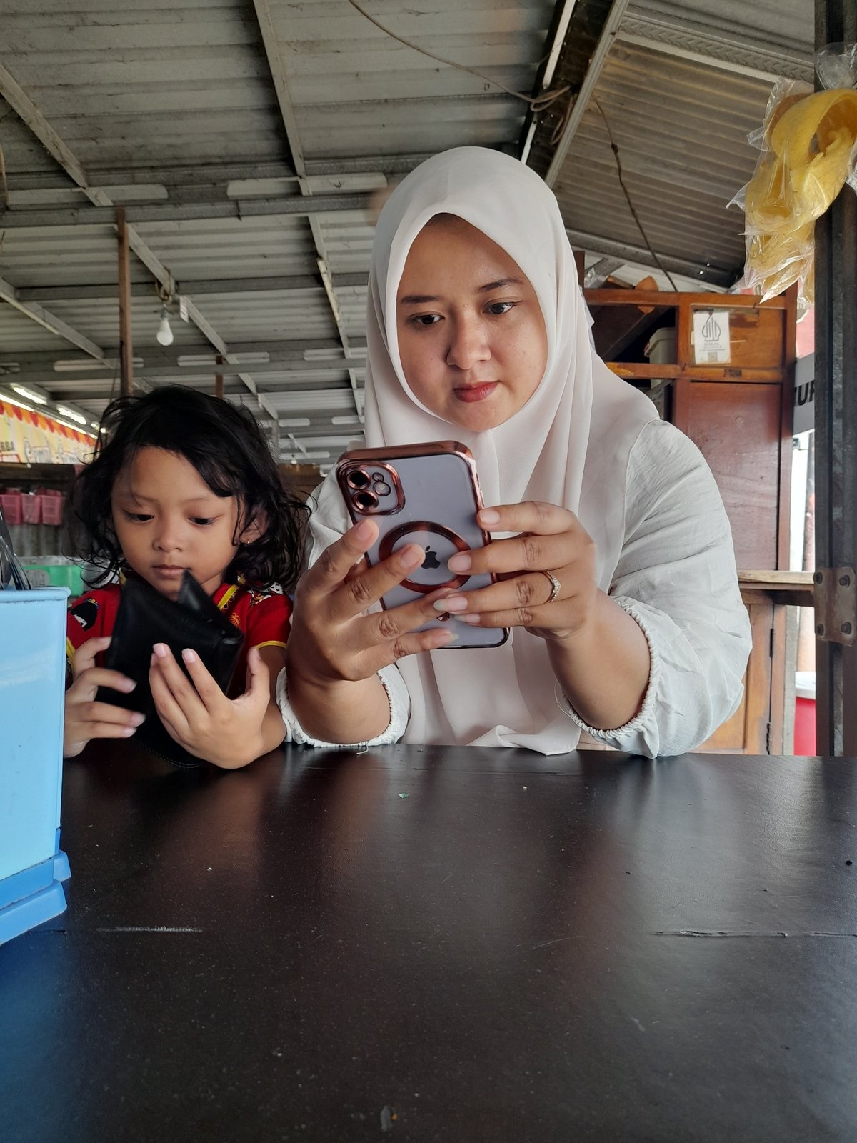 Family shares meal, photos at waterside restaurant in Indonesia