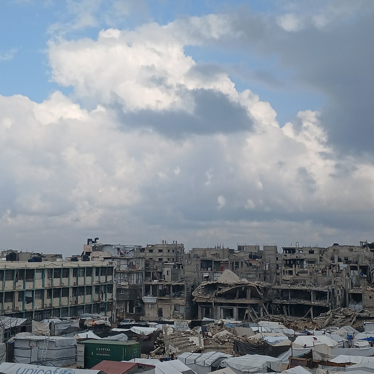Gaza displacement camps, destroyed buildings, emergency food preparation documented