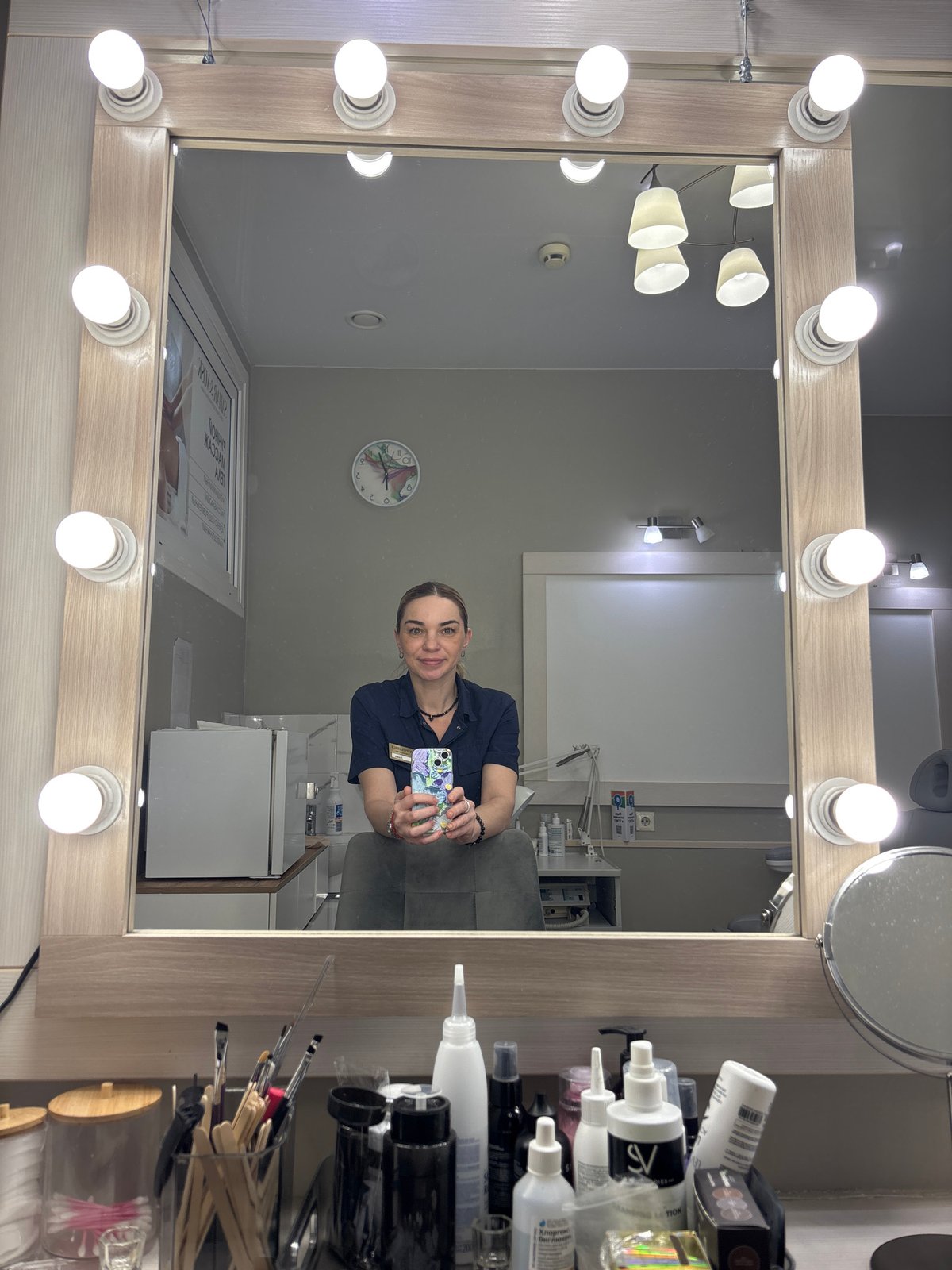 Woman Takes Selfie in Beauty Salon Vanity Mirror