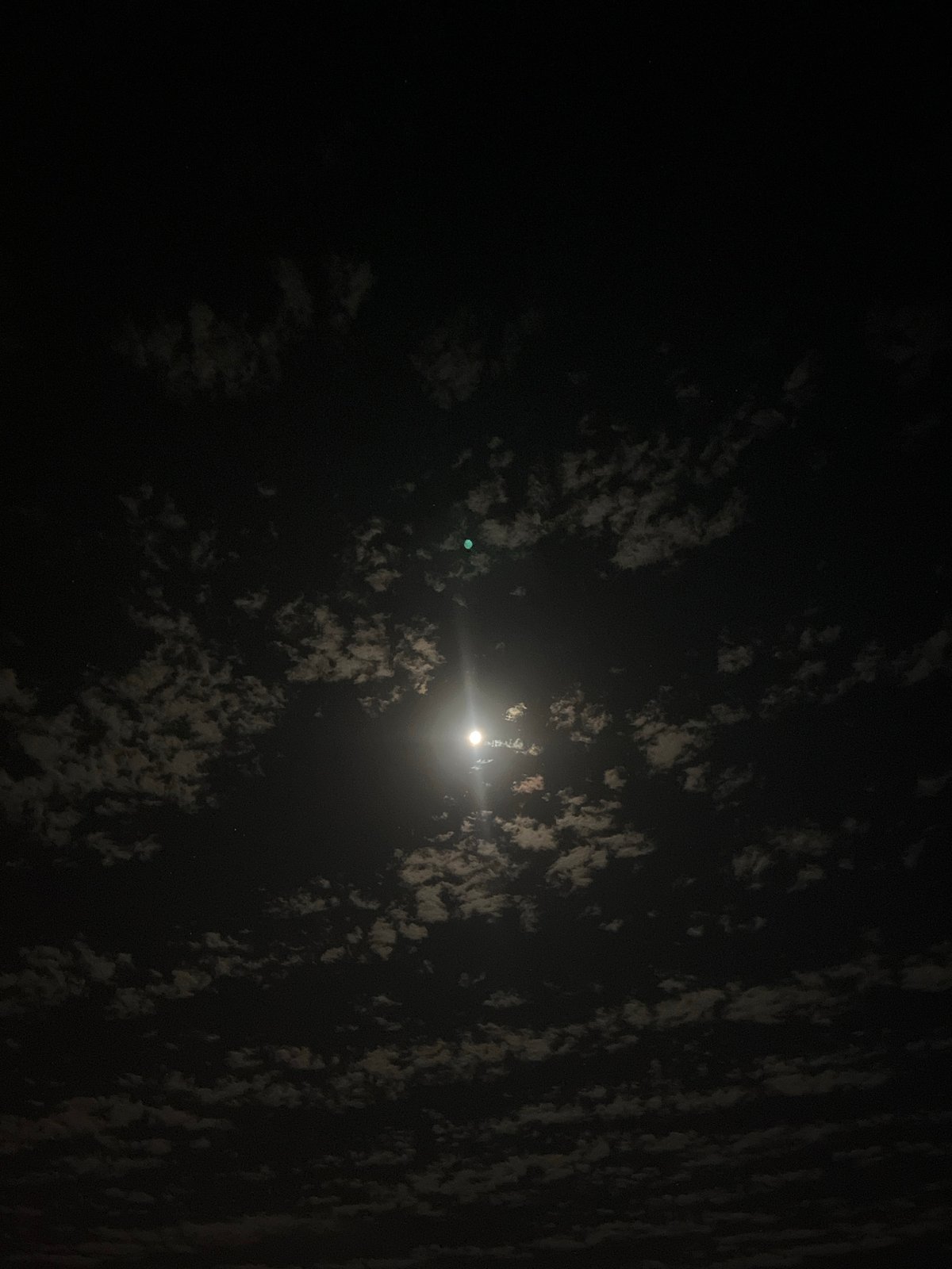 Nighttime construction activity observed under moonlit sky