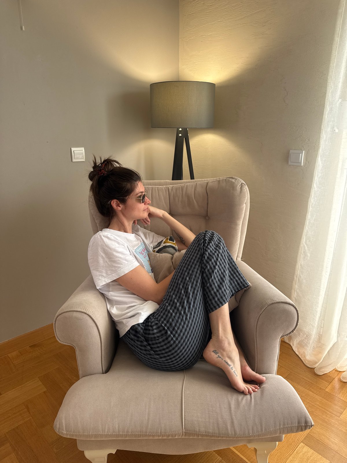 Woman enjoys quiet morning moments in Podgorica apartment