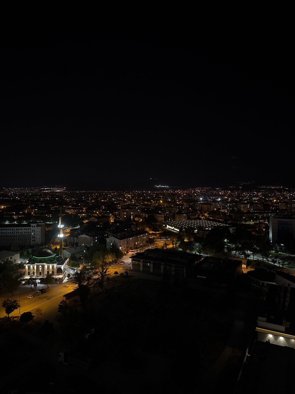 Konya skyline transitions from dusk to night, minarets lit up