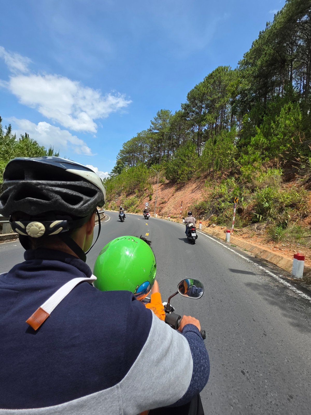 Motorcycle riders travel through Thôn 5 Vietnam early morning