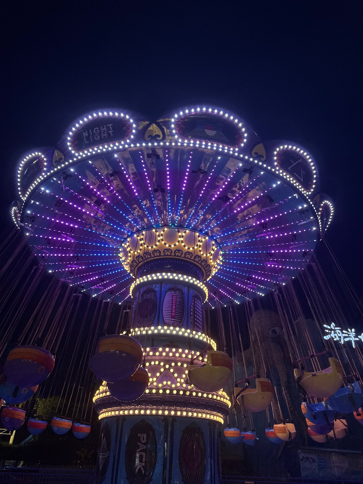 Yiwu amusement park glowing at night with rides and light installations