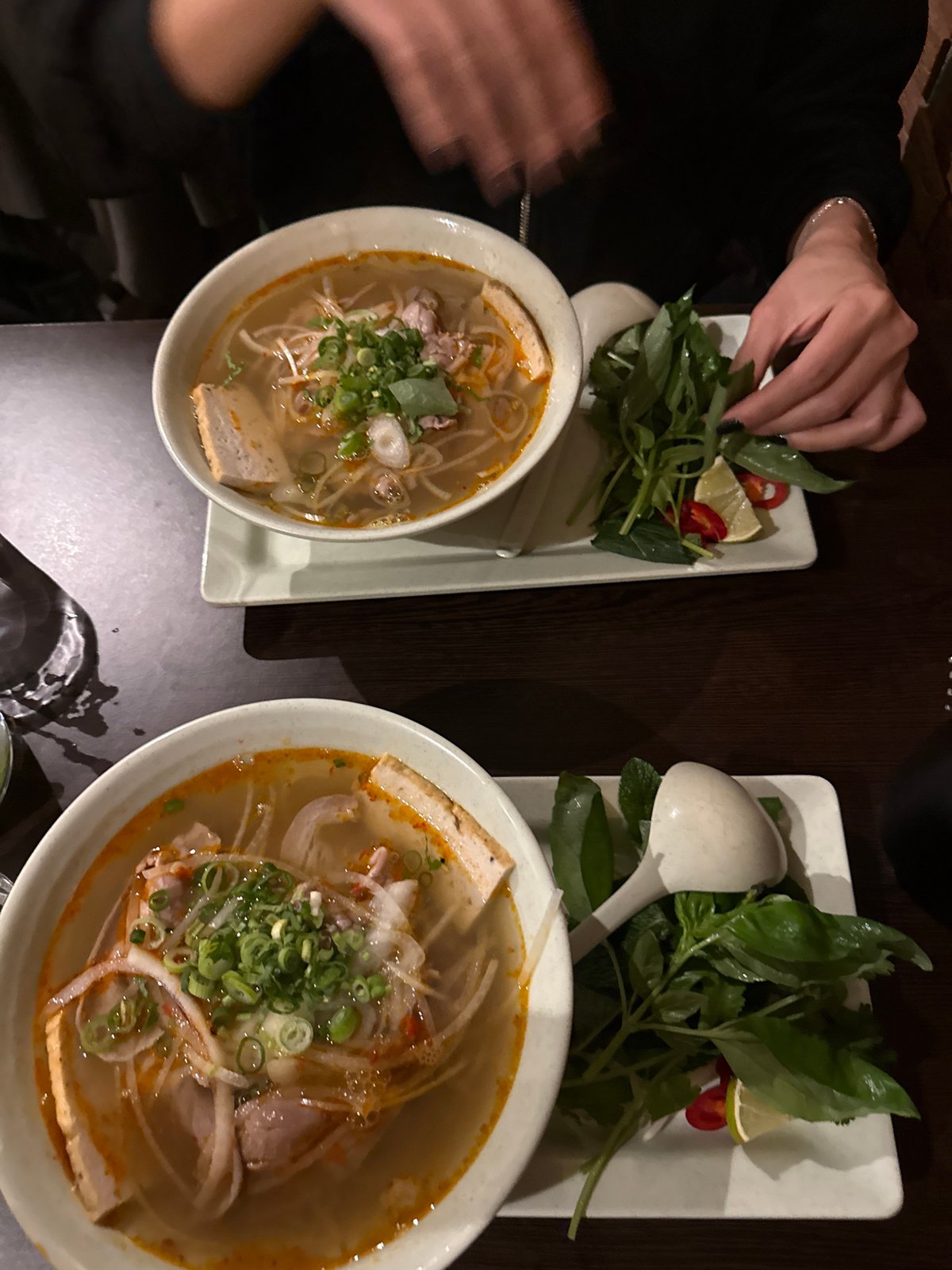 Diner customizes Vietnamese soup with herbs at London restaurant
