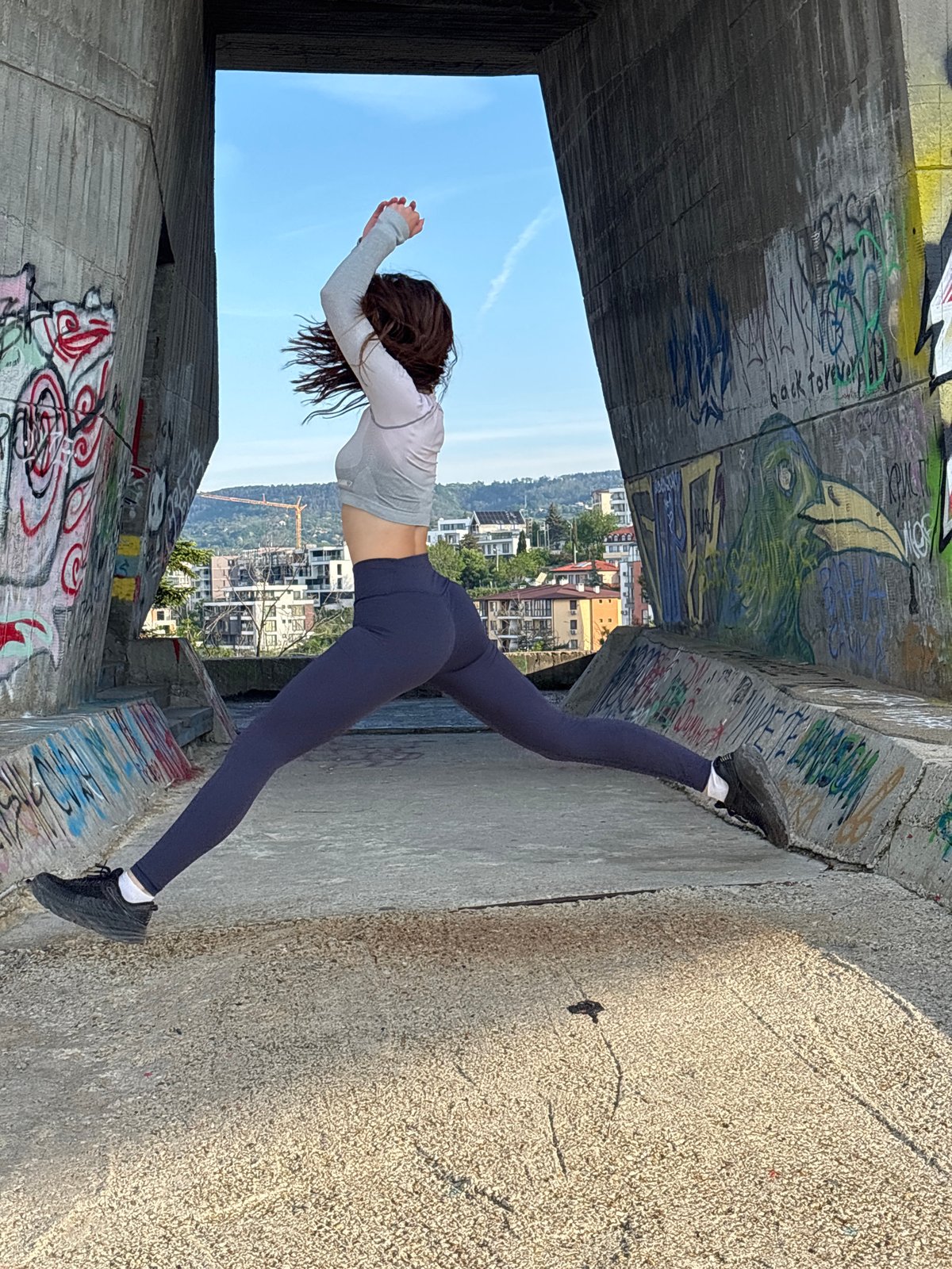 Early morning yoga session at graffitied Soviet monument in Varna