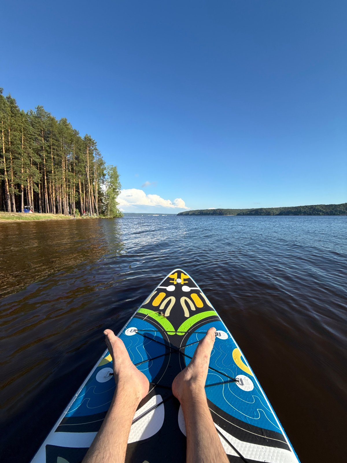 Afternoon paddleboarding session in Russian lakeside settlement