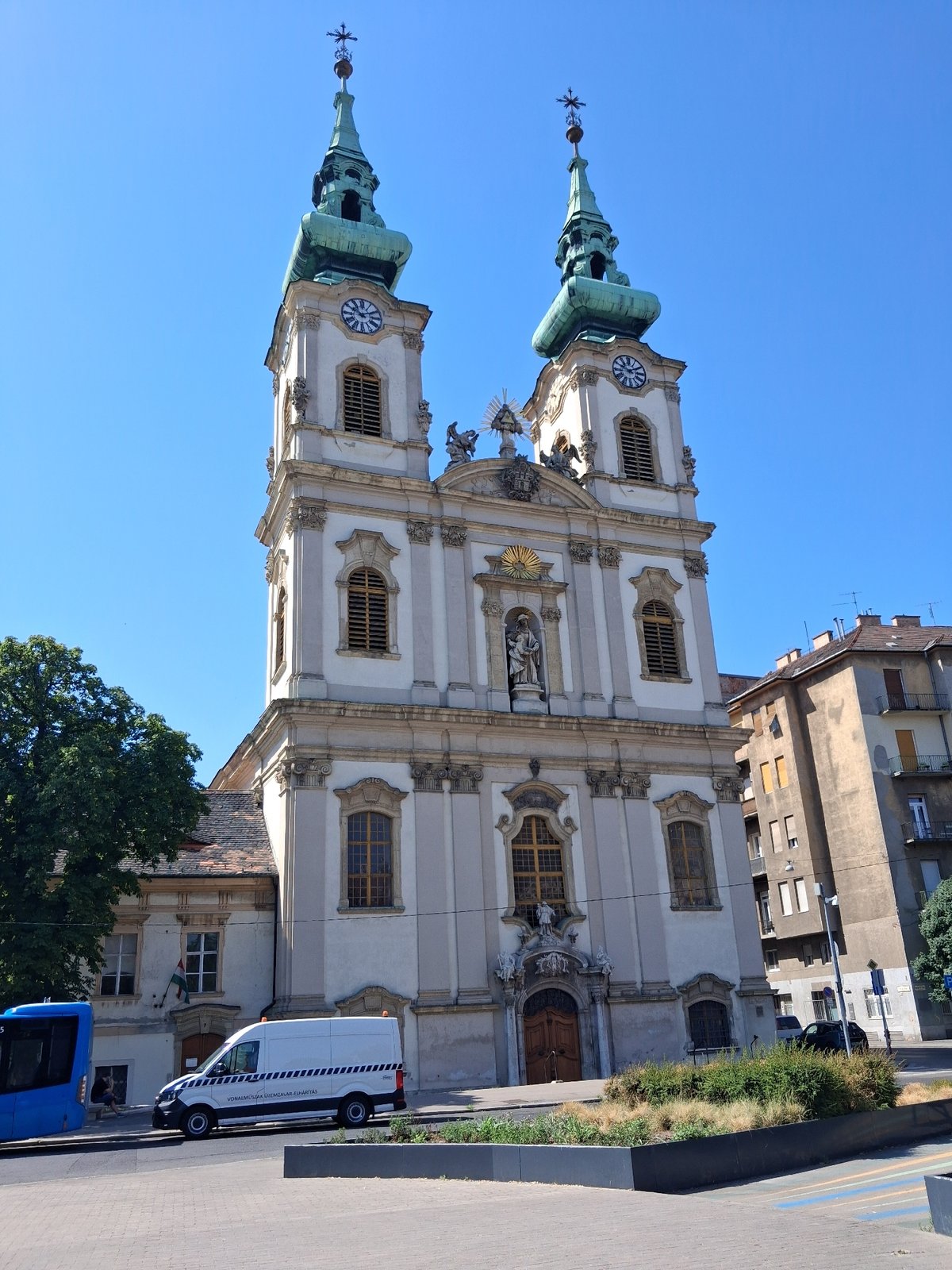 Baroque church and a resting dog on a sunny Budapest morning