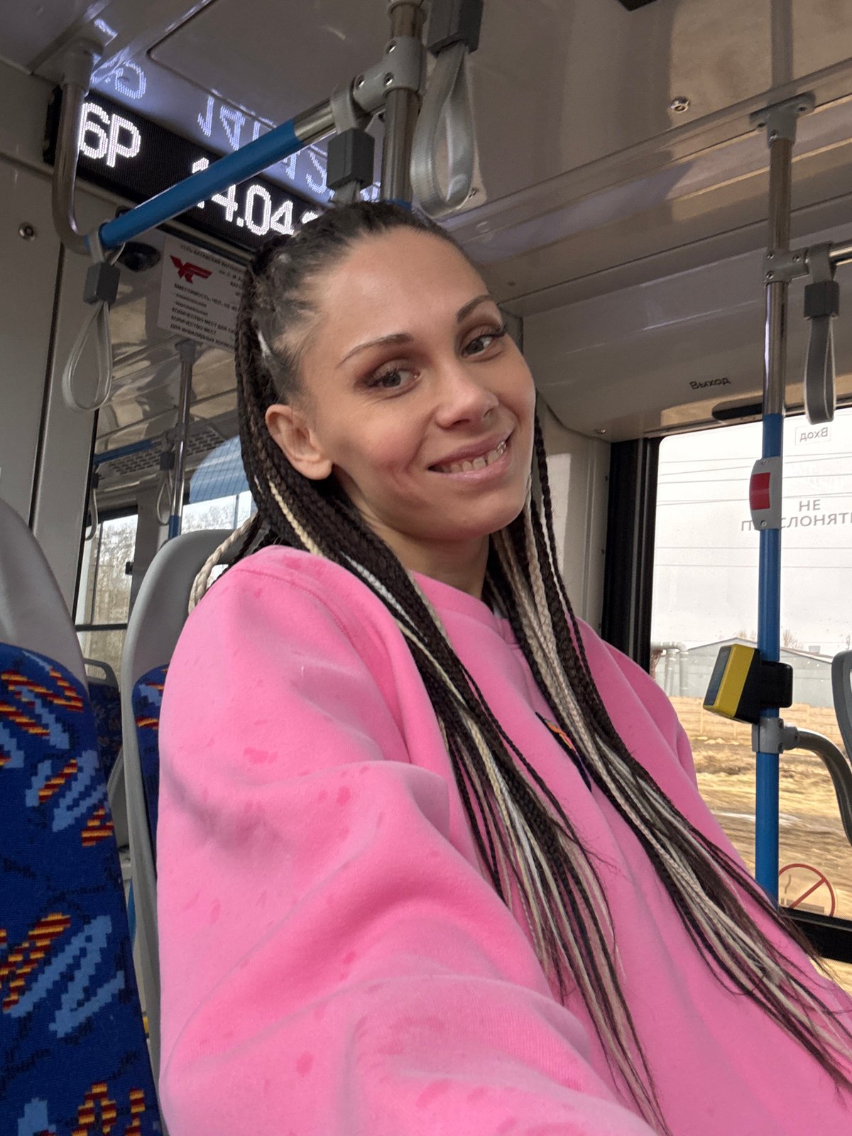 Woman documents public transit journey in pink sweater