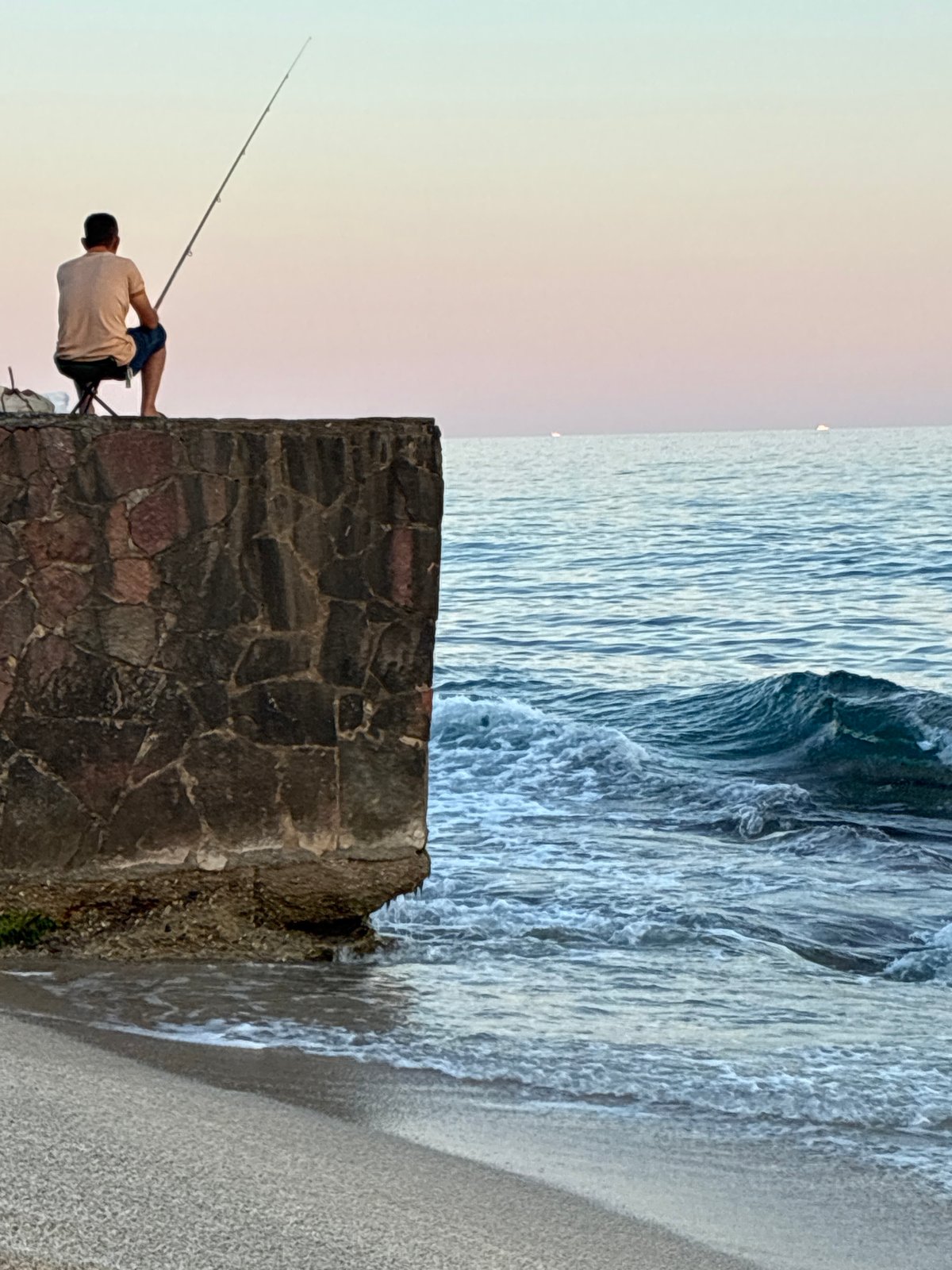 Sunset evening on the Alanya coast: beach, paddleboarding, fishing
