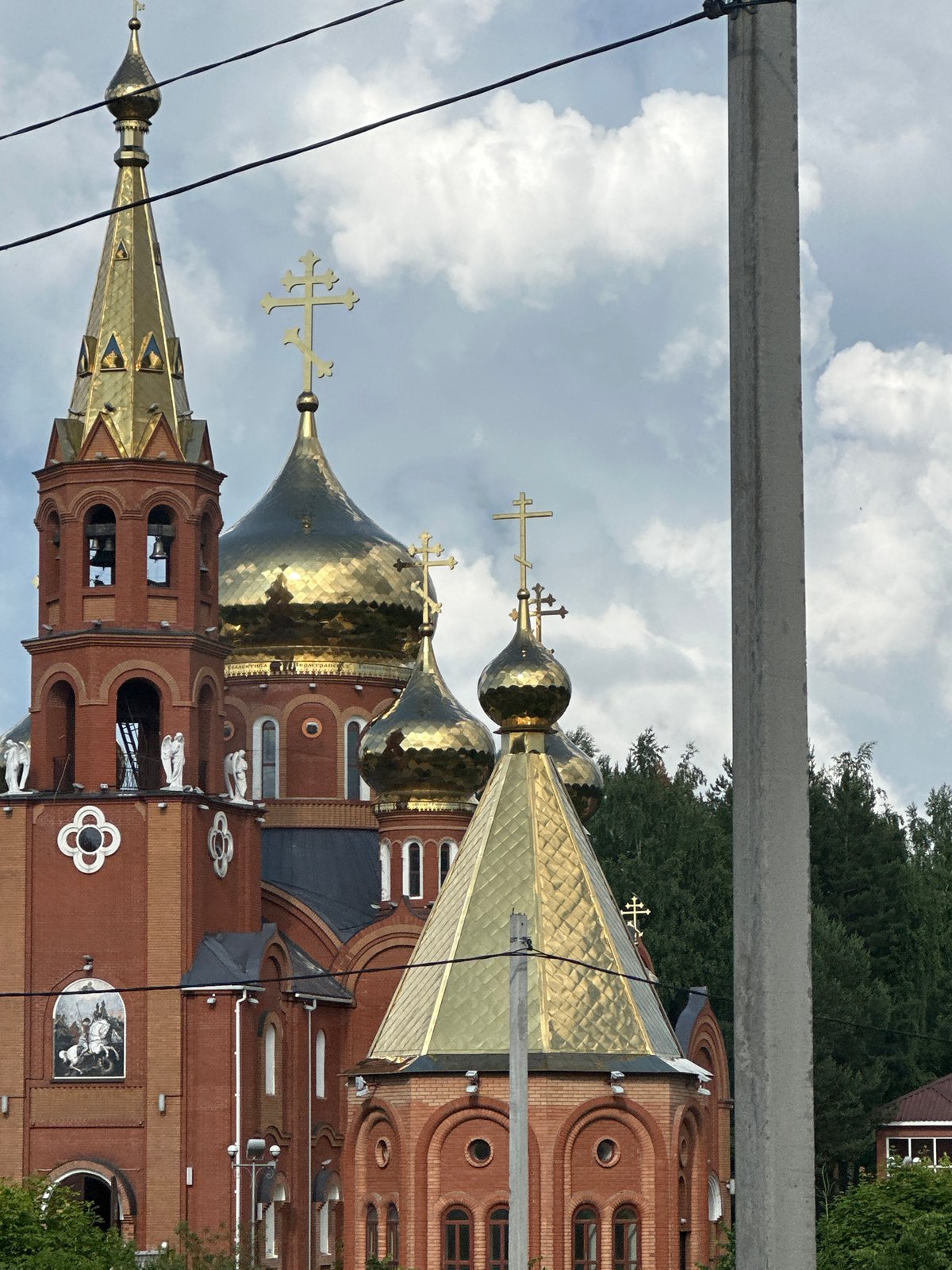 Double rainbow over Russian Orthodox church and forests