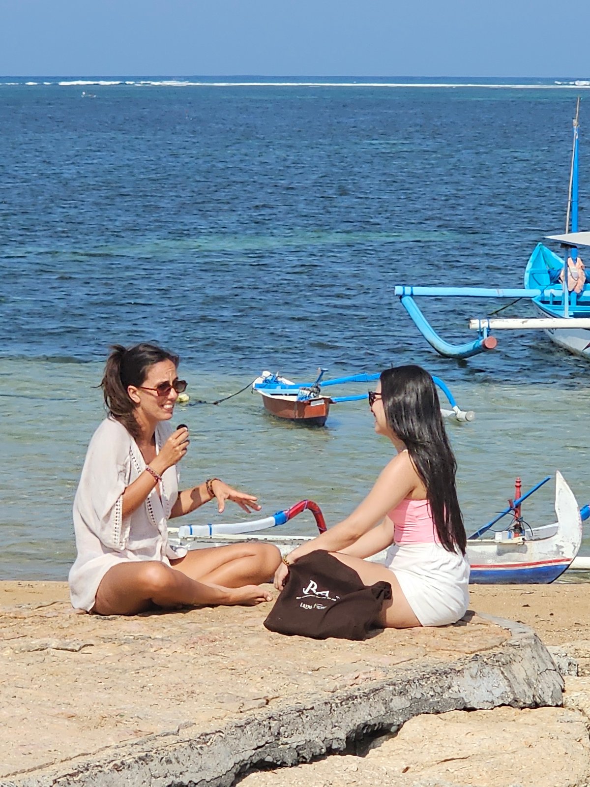 Beach morning in Denpasar: swimming, shoreline, and sand