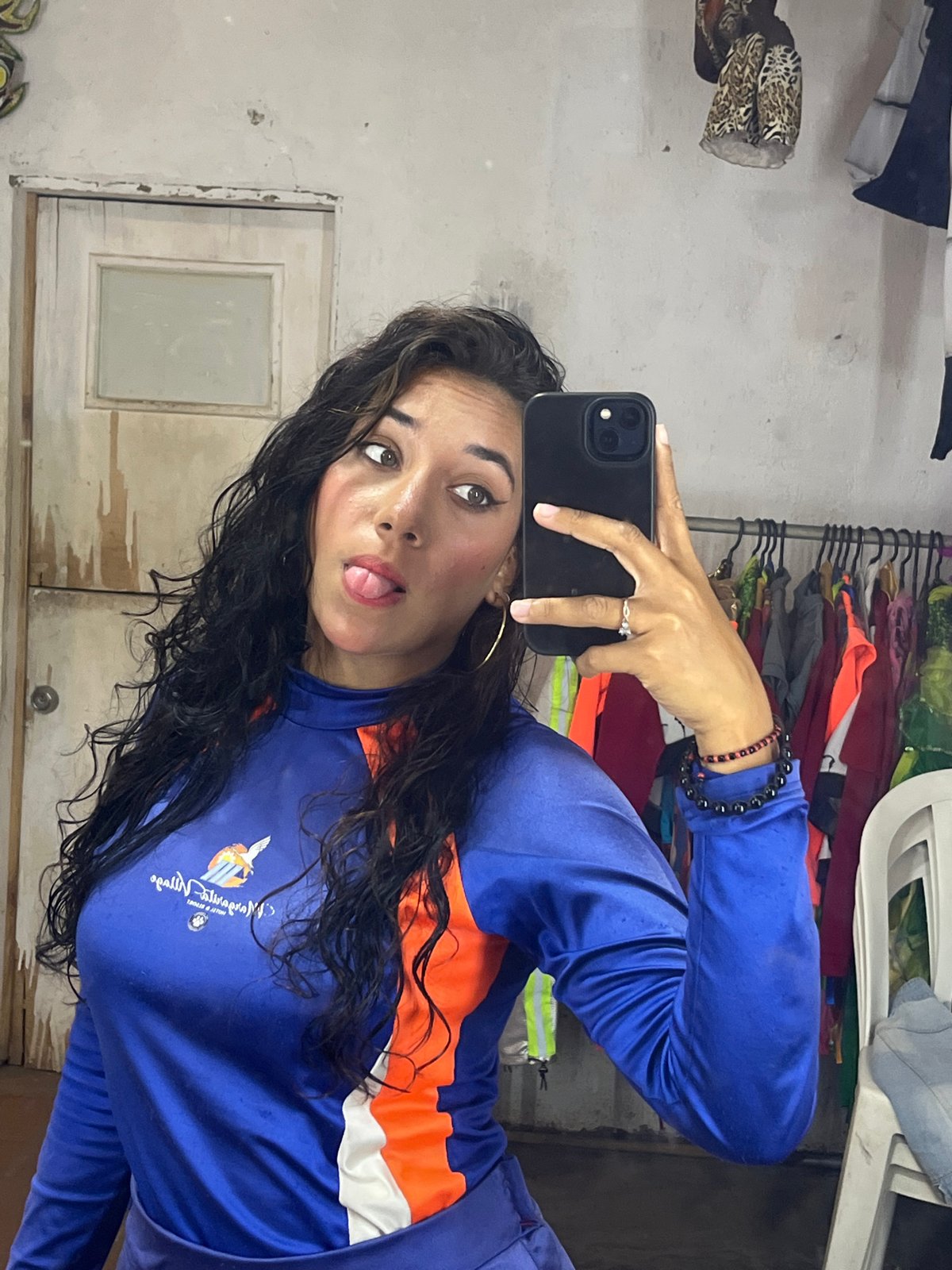 Woman takes selfies in cluttered room in Porlamar