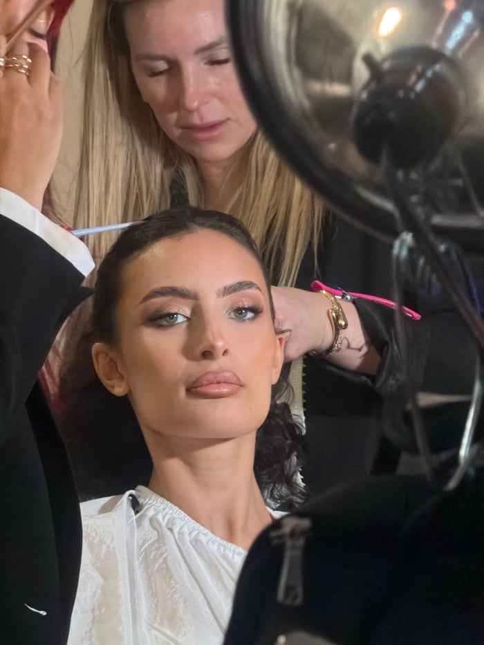 Fashion show backstage preparation documented in Paris venue