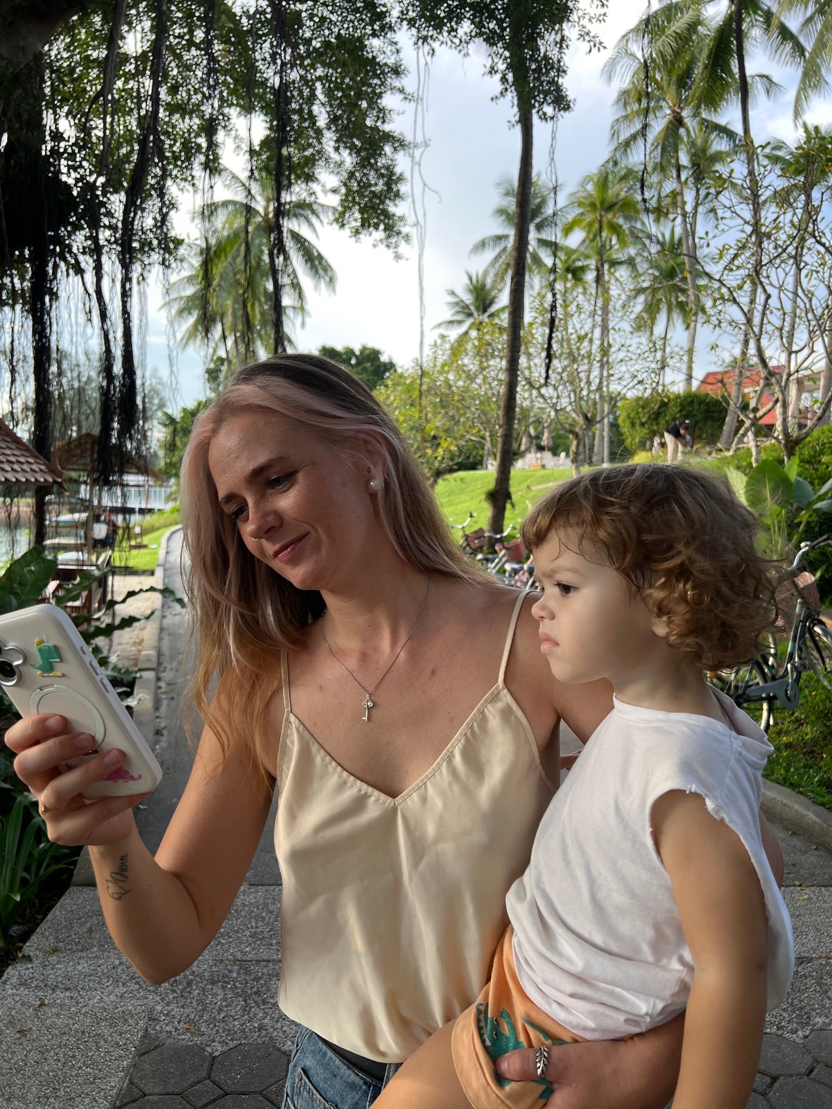 Family explores waterfront Thai-style resort with boats and beaches