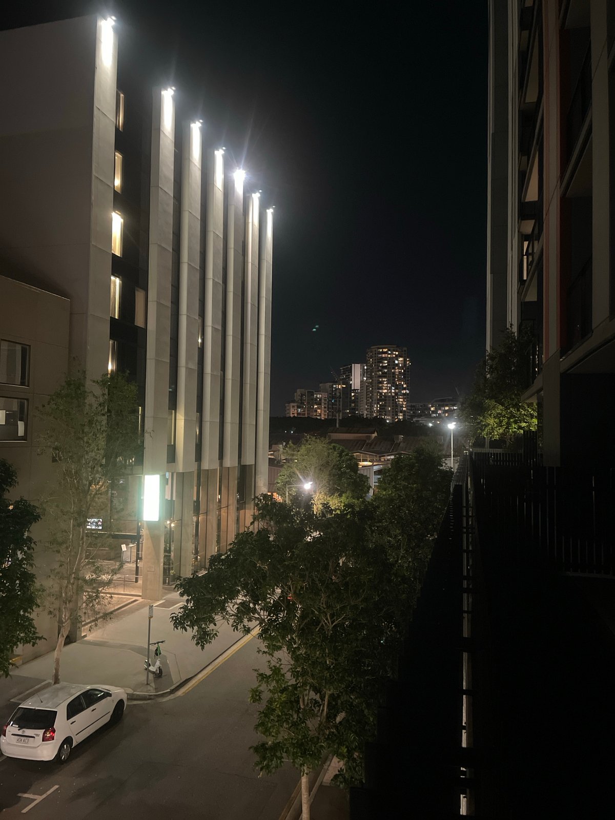 Brisbane night: city streets, a balcony, and cozy interiors