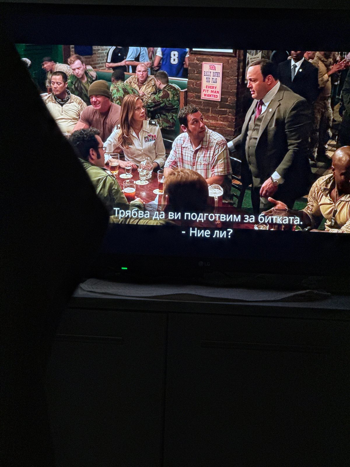 Sofia resident watches rotated TV showing bar scene