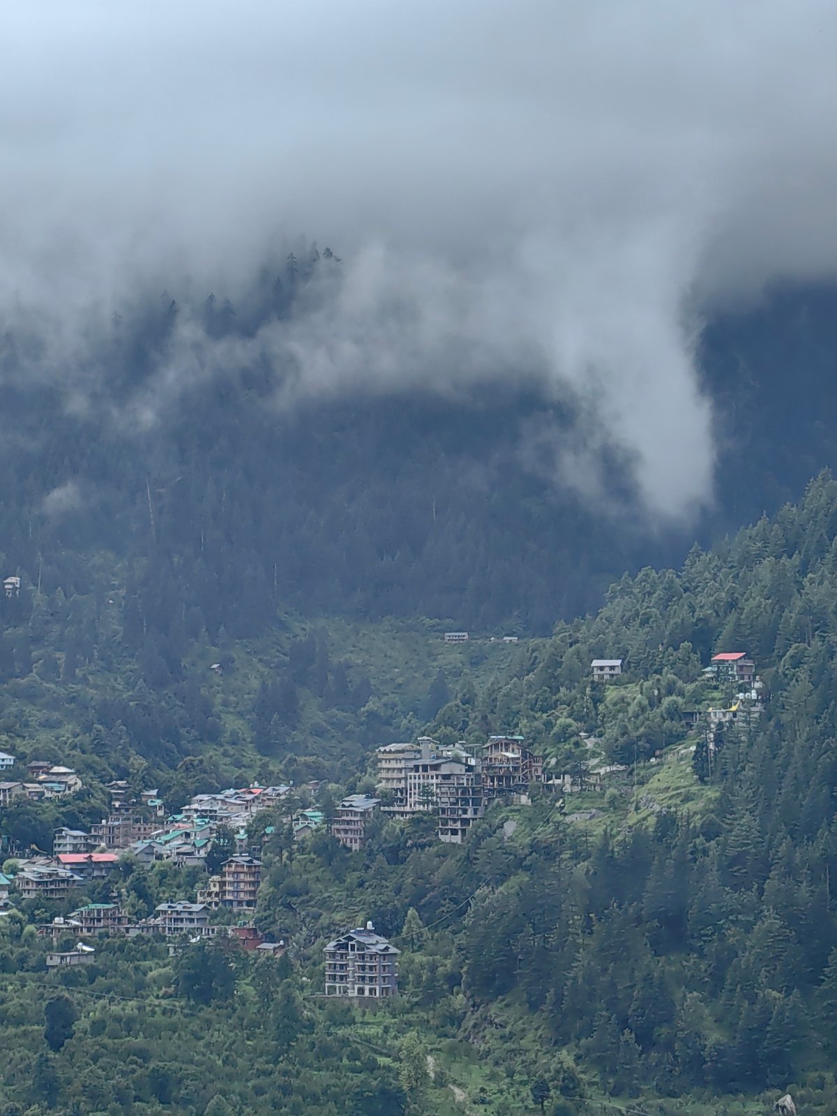 Vashisht hillside town wrapped in clouds and mountain fog