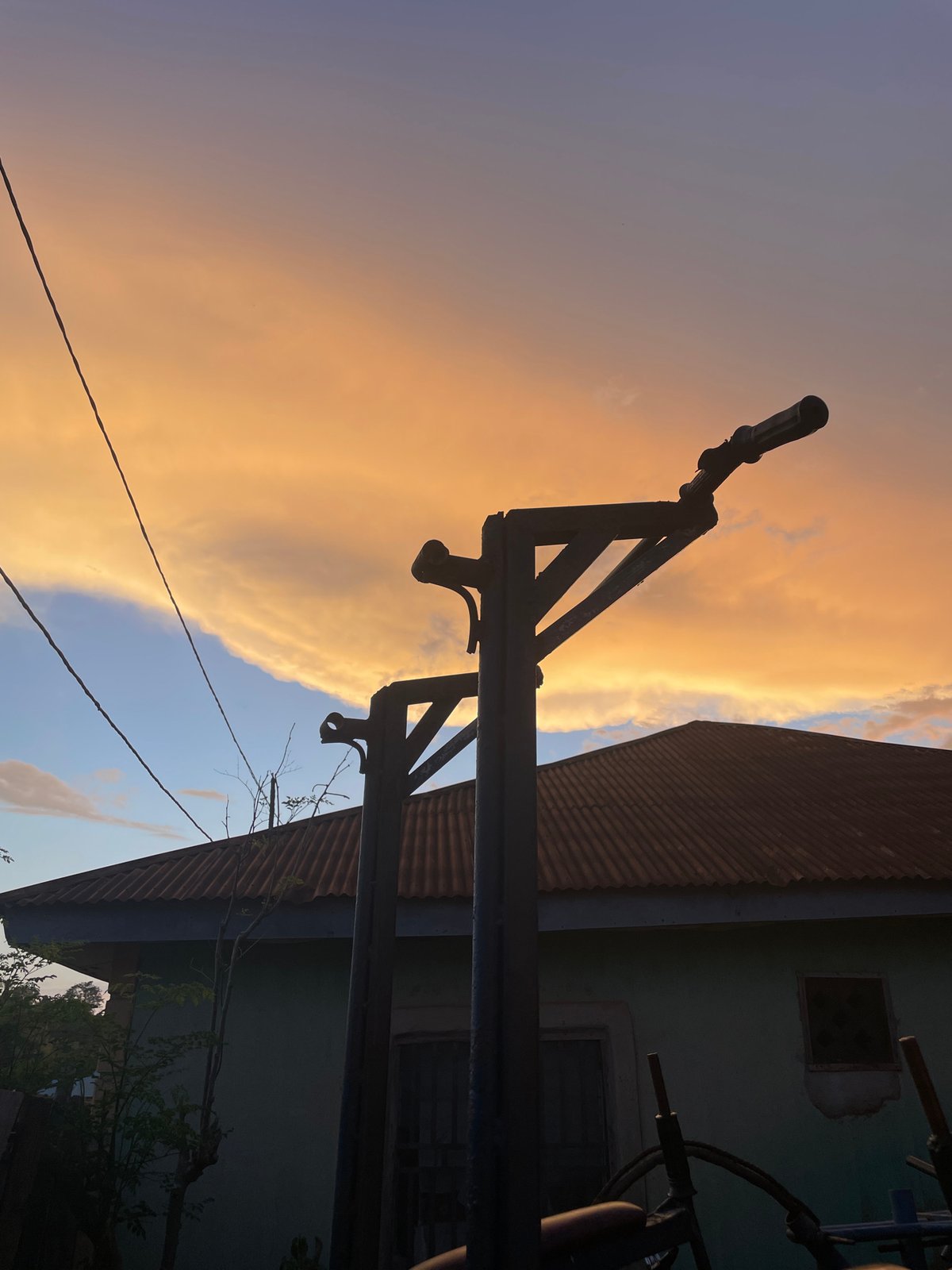 Men exercise with homemade weights during sunset in Akwanga