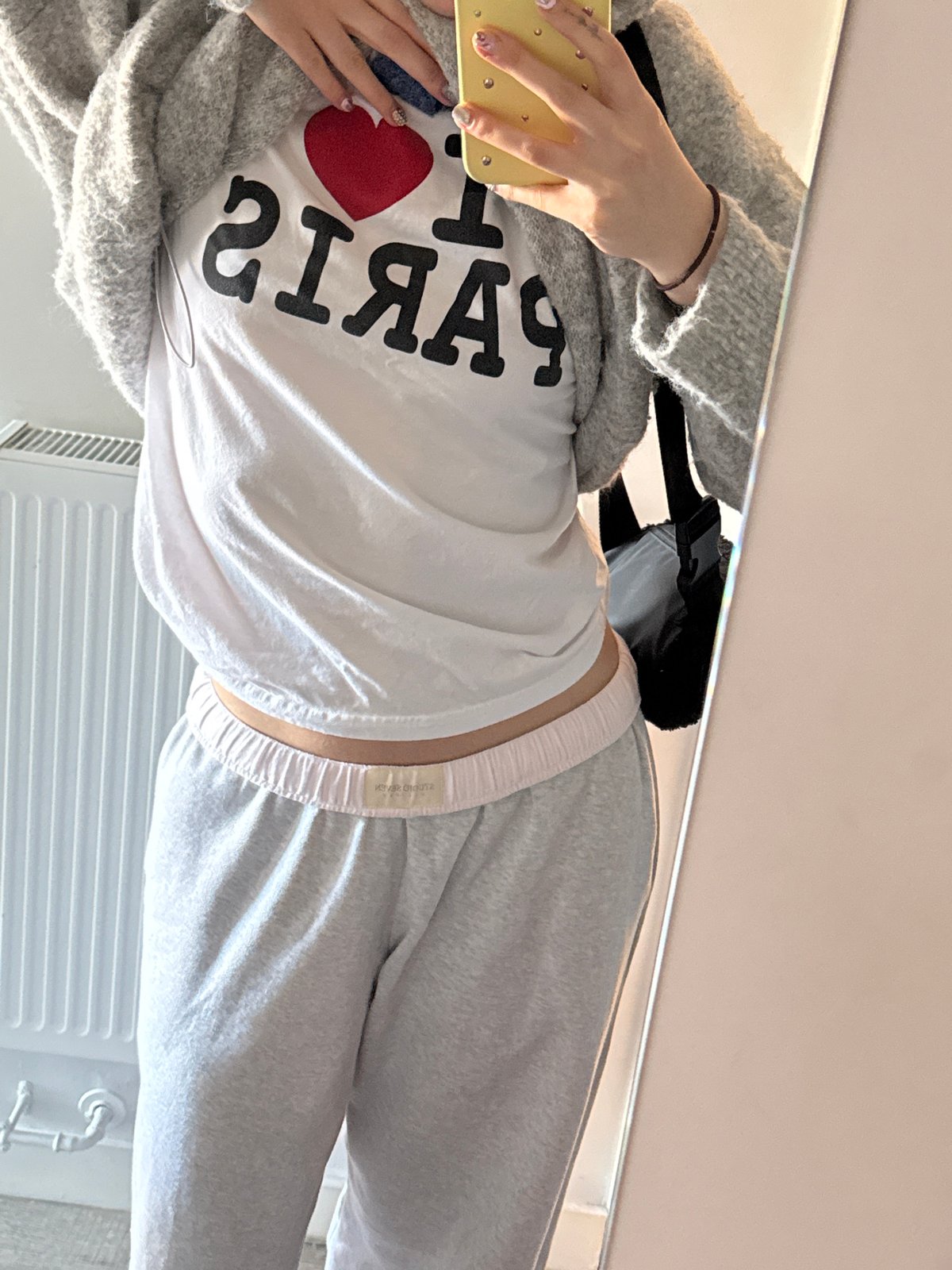 Woman takes mirror selfies with headphones in Hull apartment