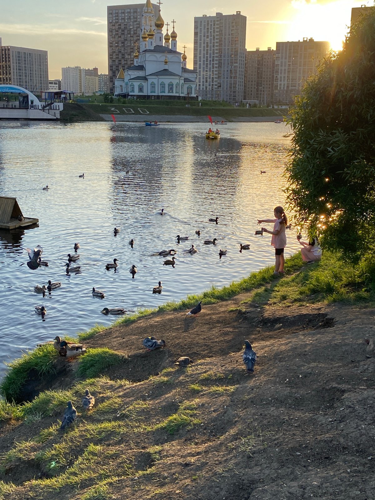 Yekaterinburg residents enjoy afternoon outdoors near churches and lakes