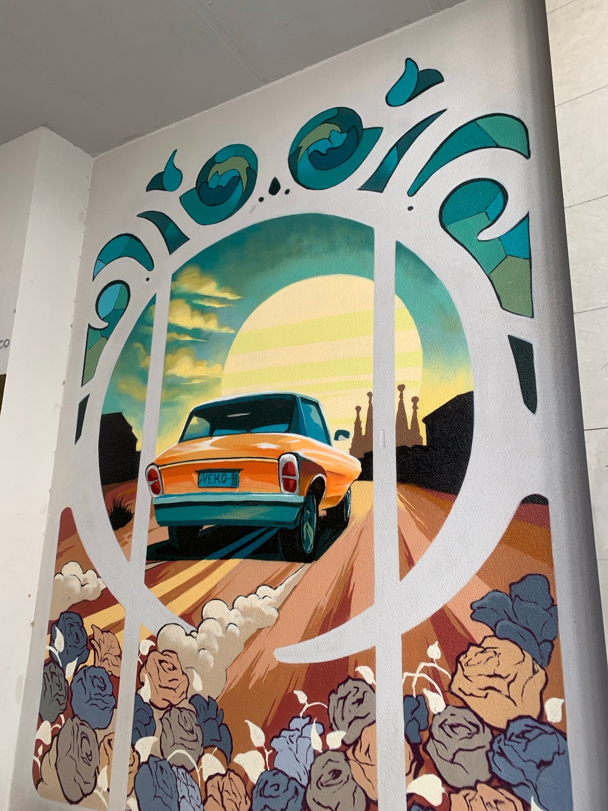 Orange car mural depicts departure from Barcelona cityscape