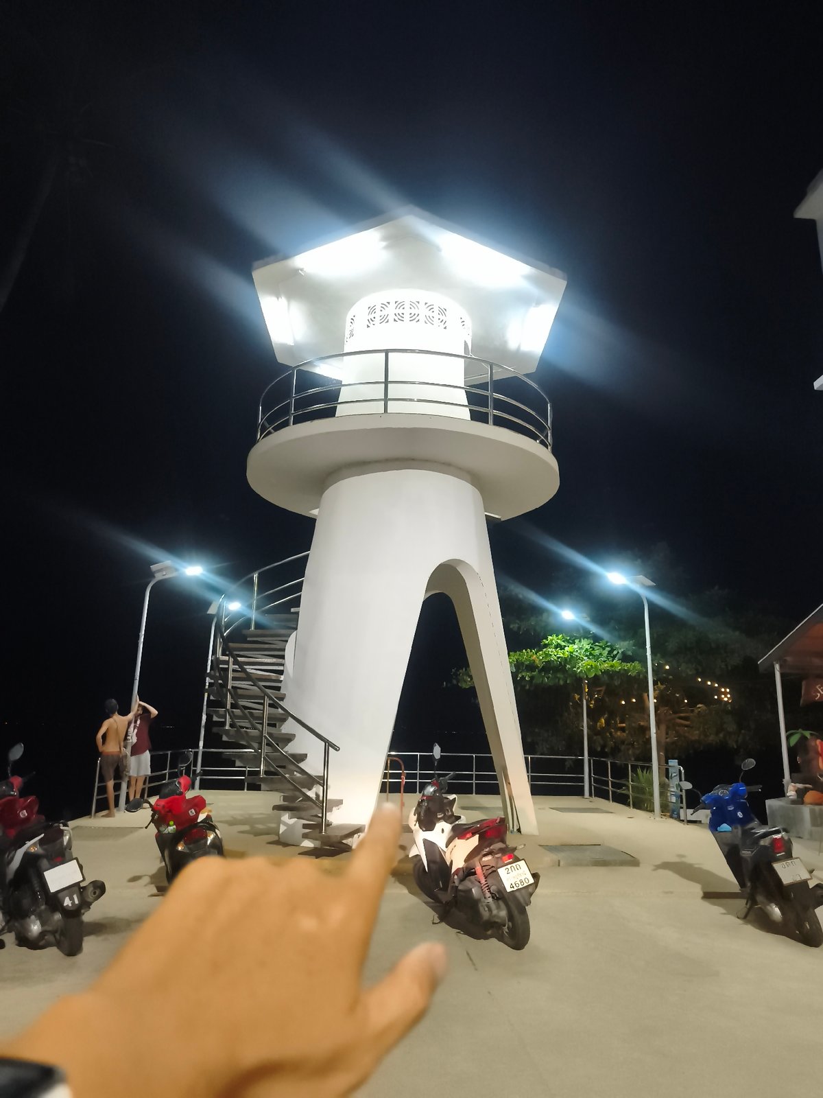 Nighttime street documentation captures illuminated landmarks in Baan Mae Nam