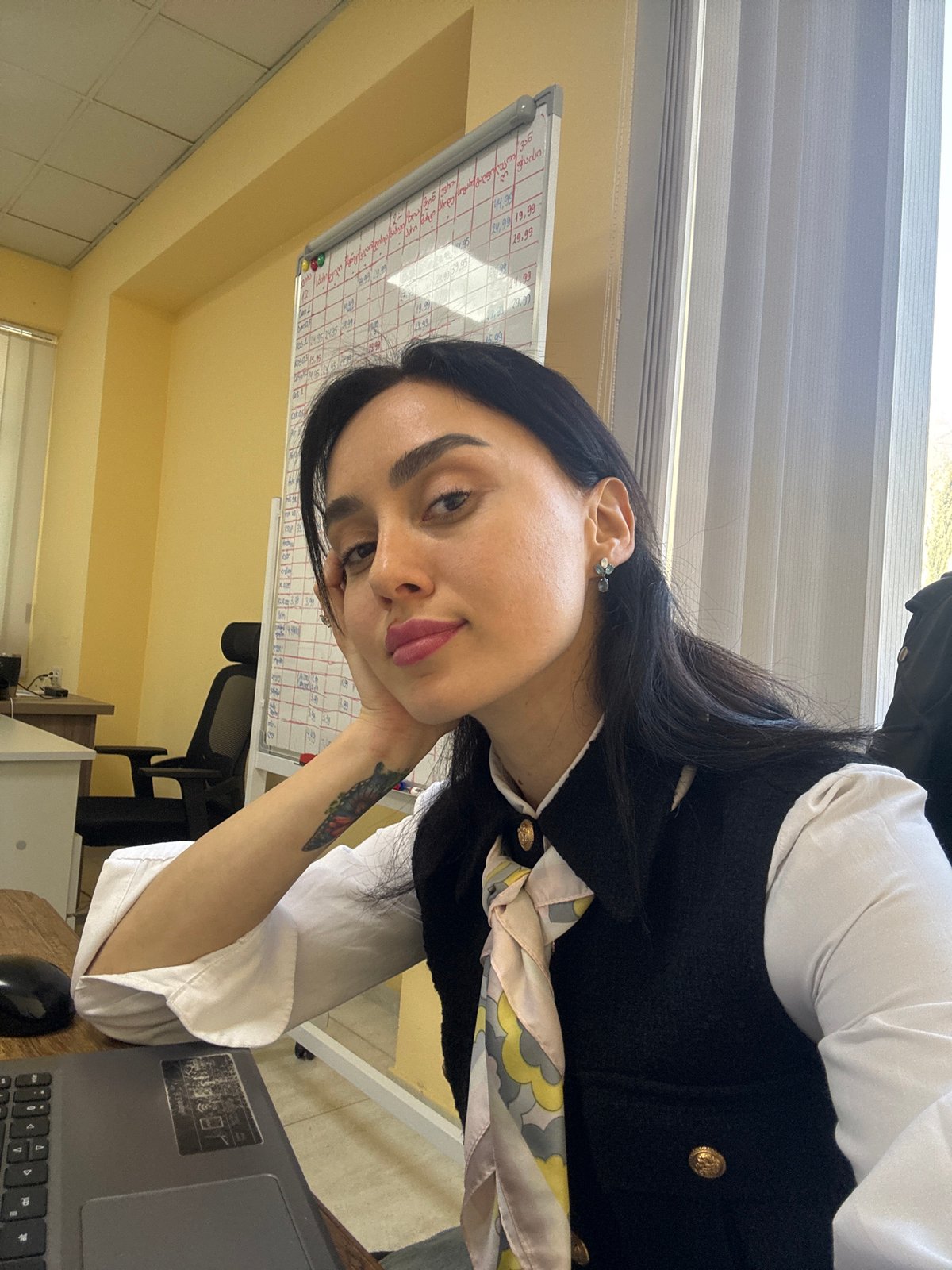 Woman photographed in playful poses at Tbilisi office location