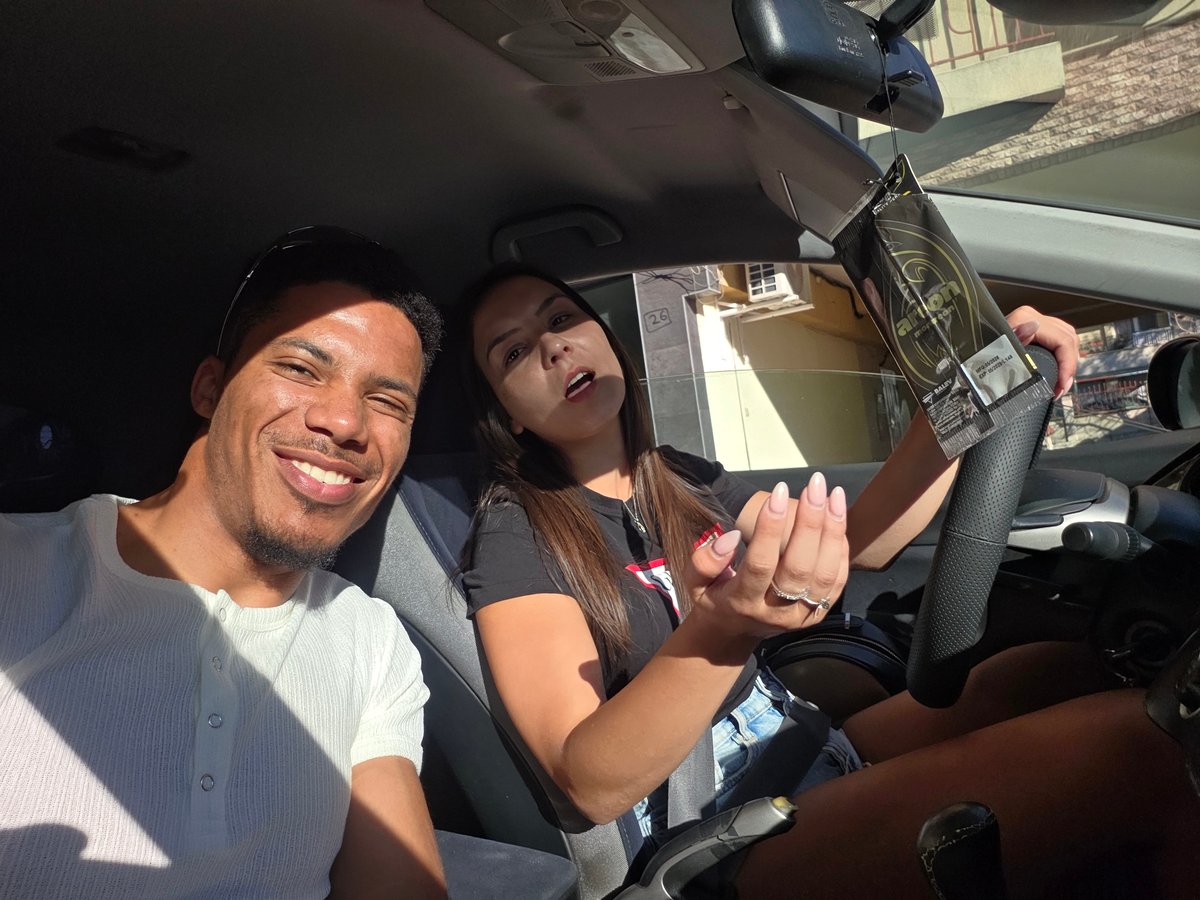 Inside a car in Varna, two people pause for the camera.