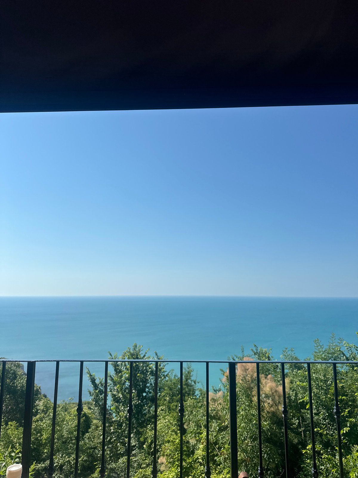 Oceanview terrace breakfast spot with yellow canopy and calm water views