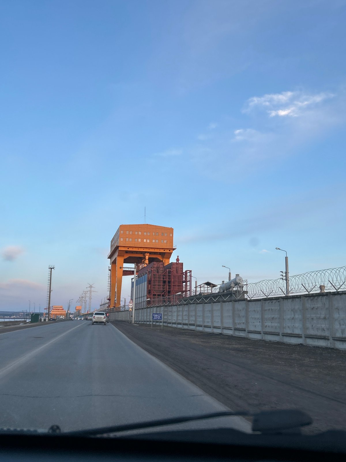 Midday journey through Chaikovsky reveals industrial landscape, frozen reservoir