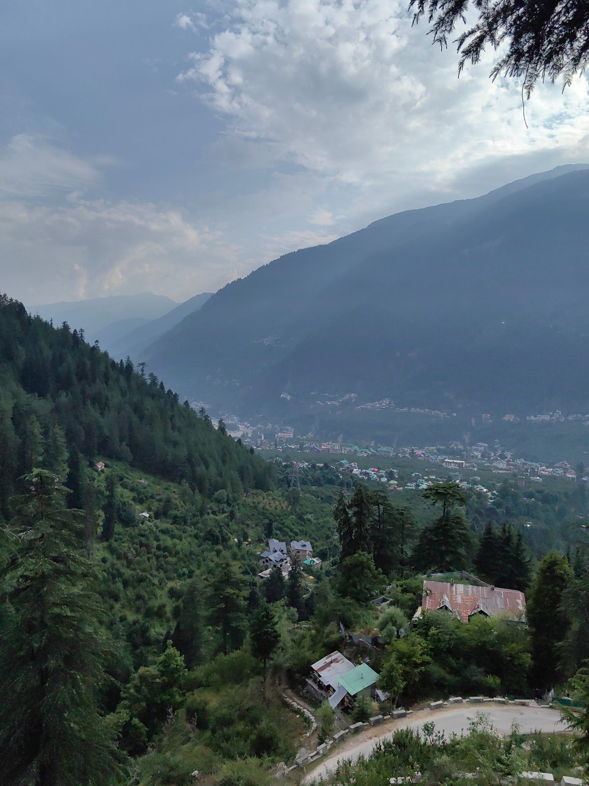 Temples, prayer flags, and mountain mist over Prini village