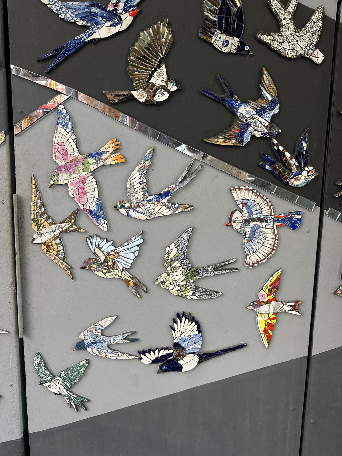 Mosaic bird wall and courtyard café scene in Saint Petersburg