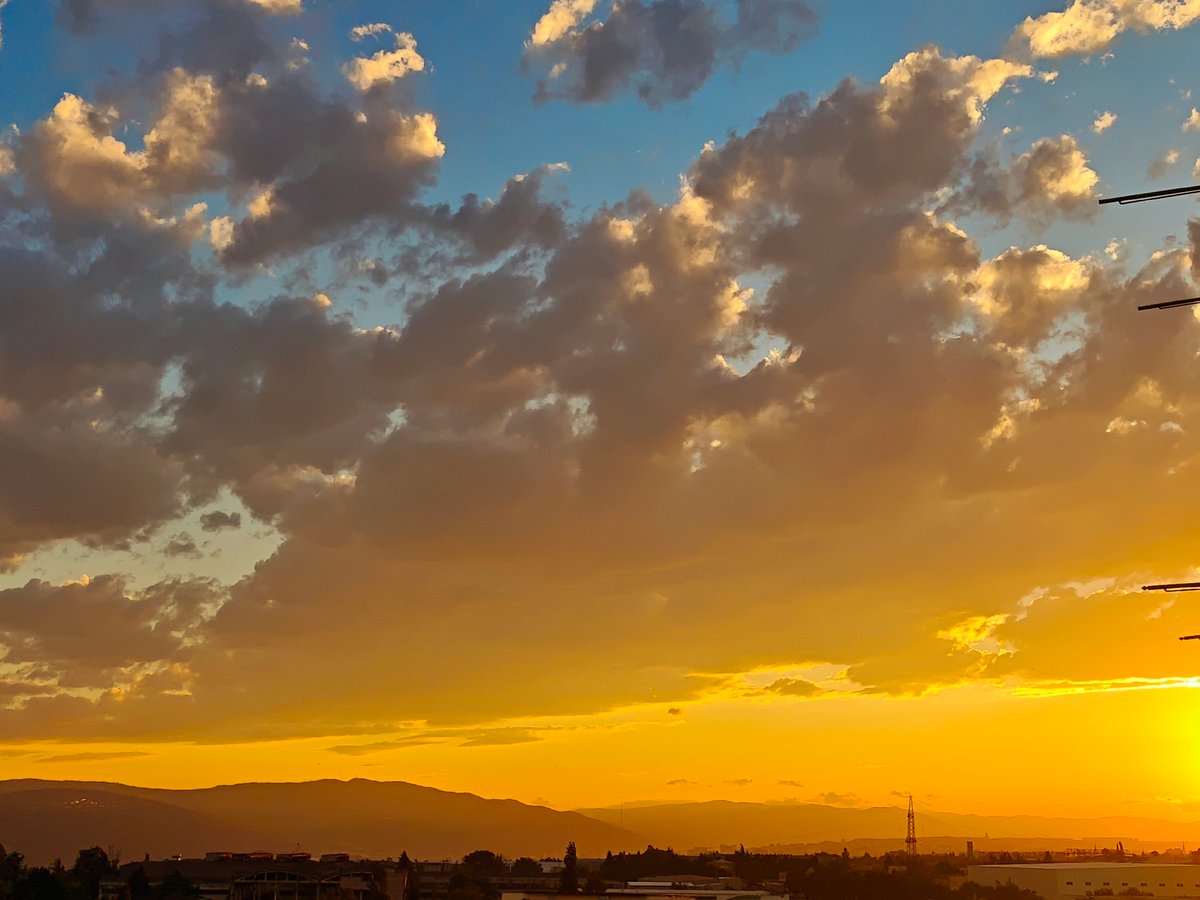Tbilisi skyline at golden hour, clouds and crescent moon