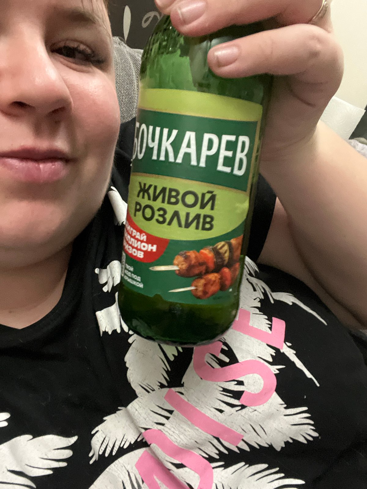 Person holds specialty Bochkarev beer bottle in Chaikovsky selfie