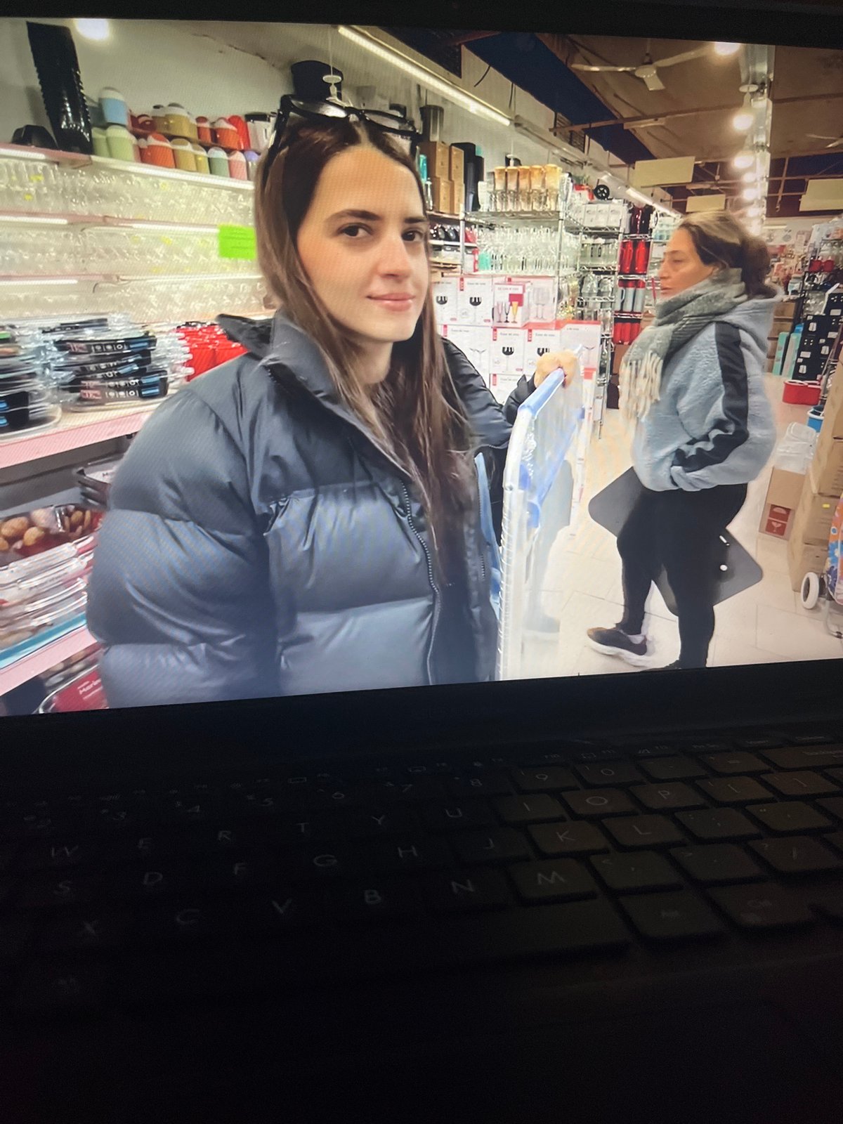 Person documents laptop screen content in Venezuelan home