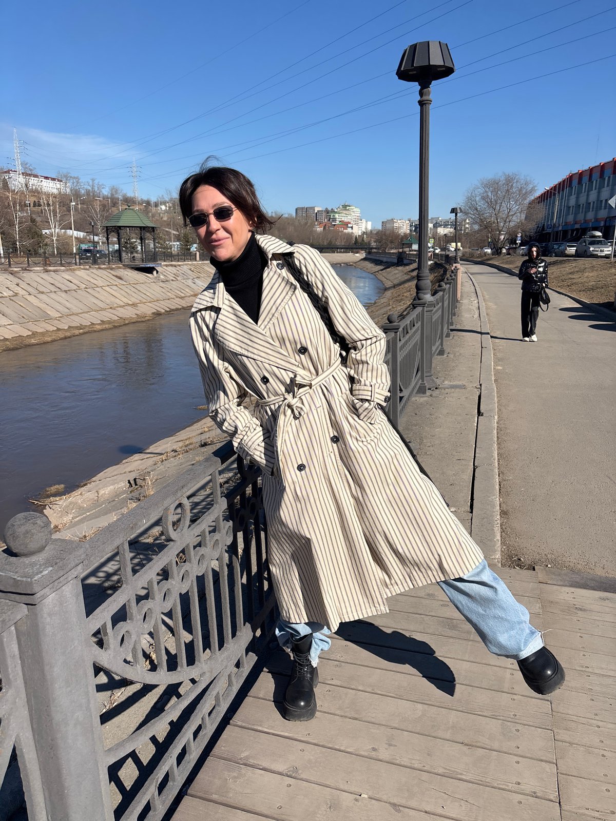 Woman photographs herself during morning walk in Krasnoyarsk