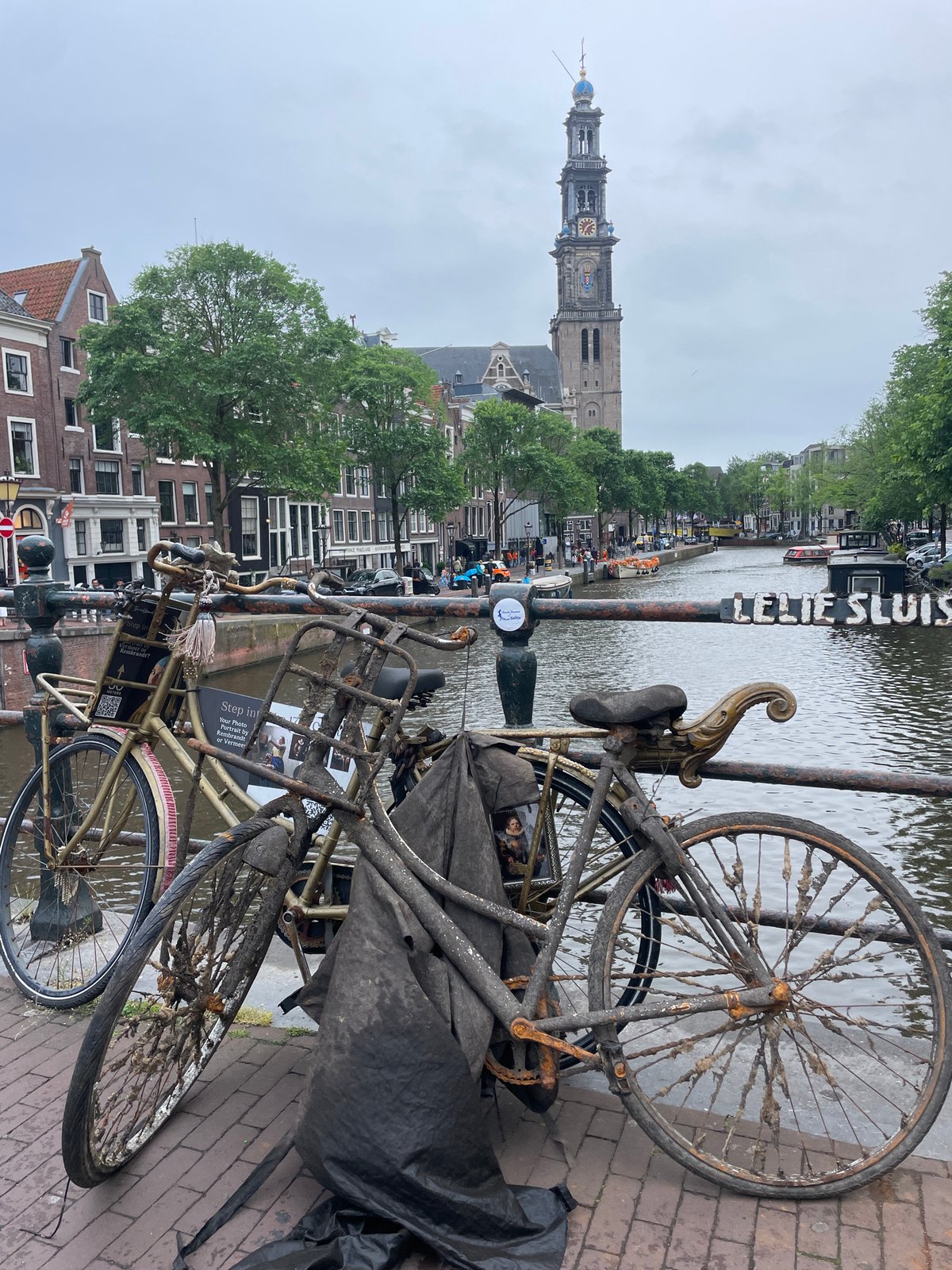 Tourist captures classic Amsterdam canal scenes during evening stroll