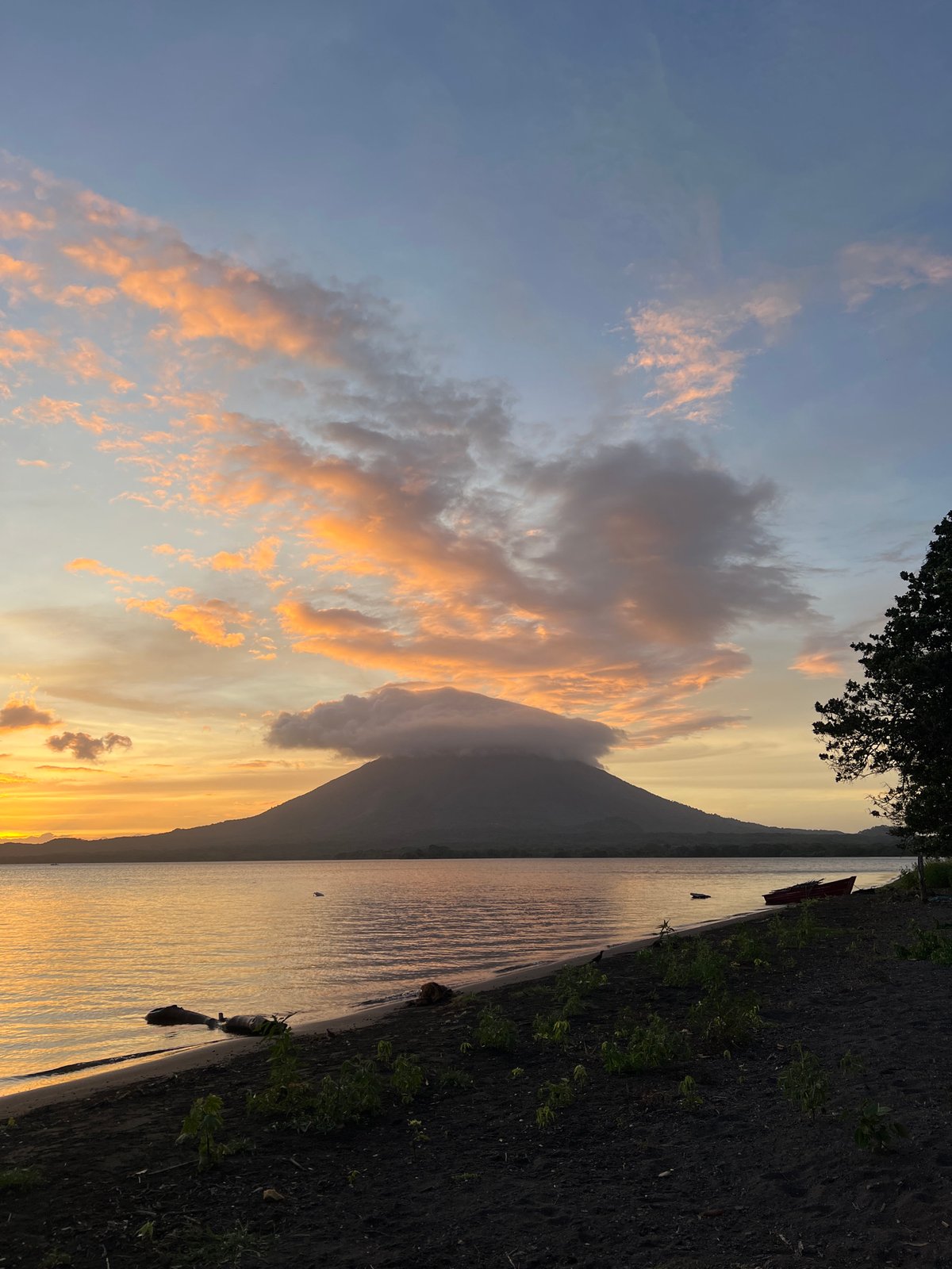 Sailboat and volcano at sunset on Lake Nicaragua
