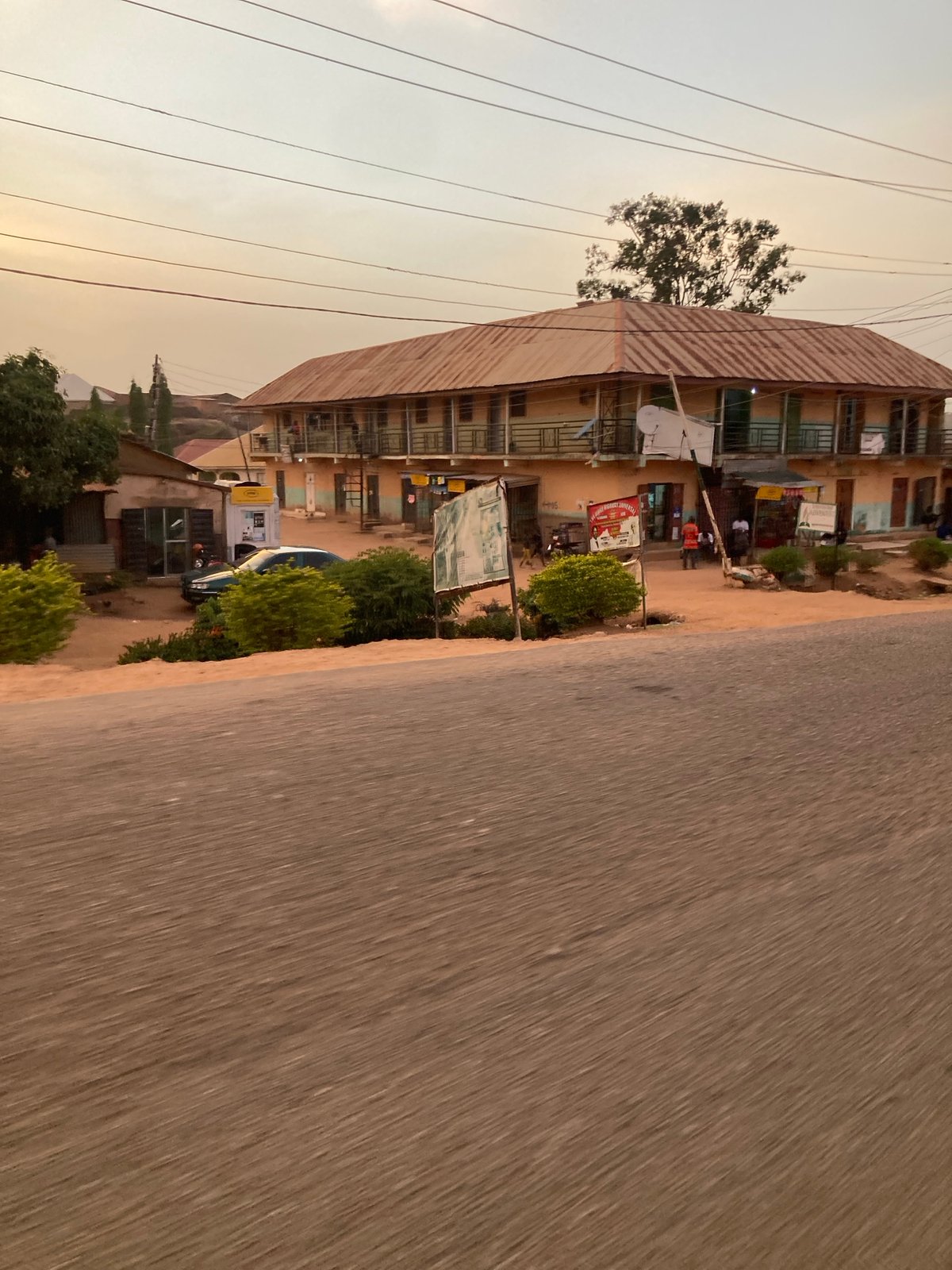Moving vehicle captures street scene in Jos, Nigeria
