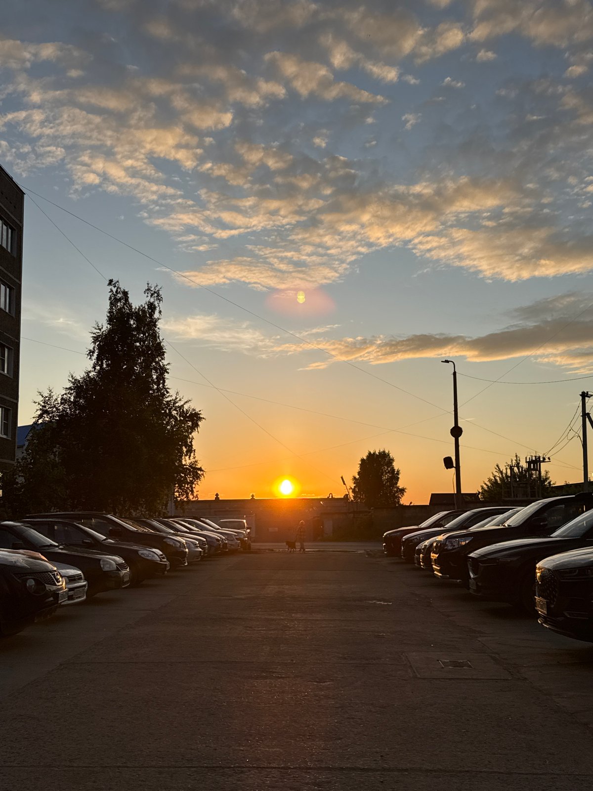 Woman documents sunset evening with selfies and pizza in Chaikovsky
