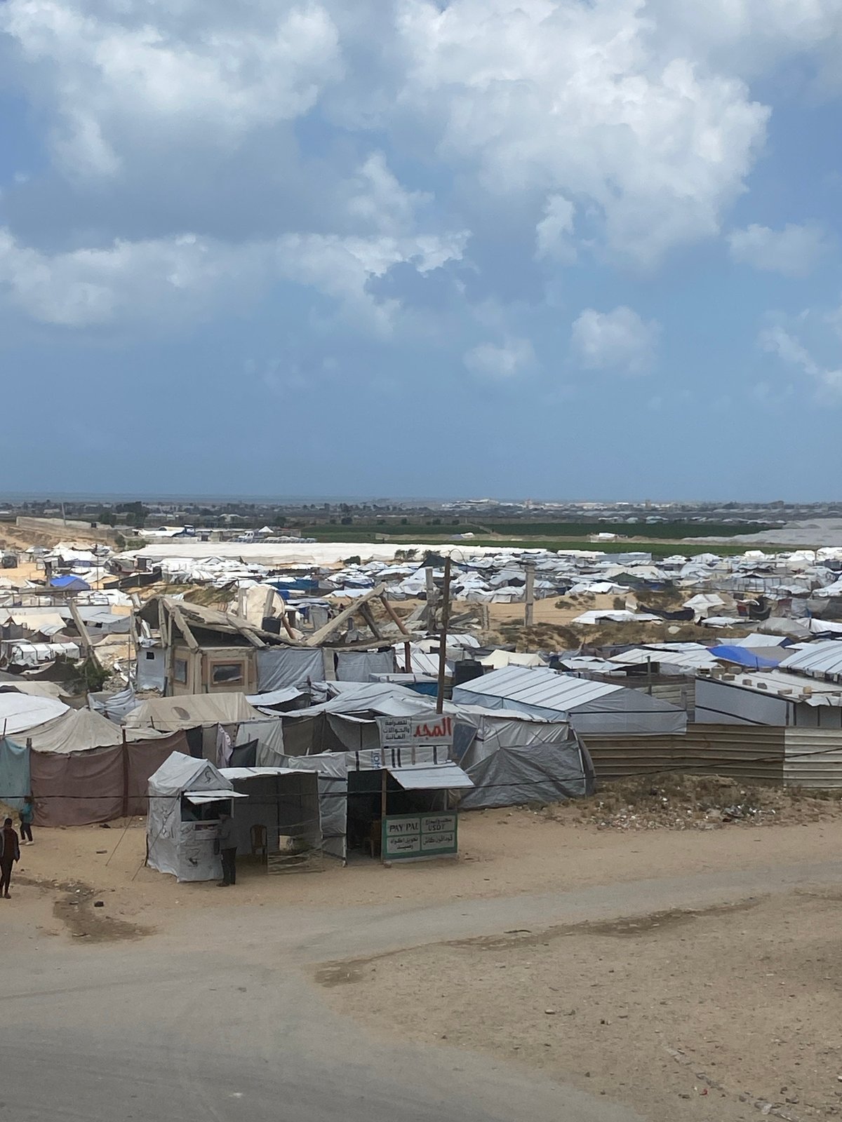 Refugee camp with makeshift shelters documented at unknown location
