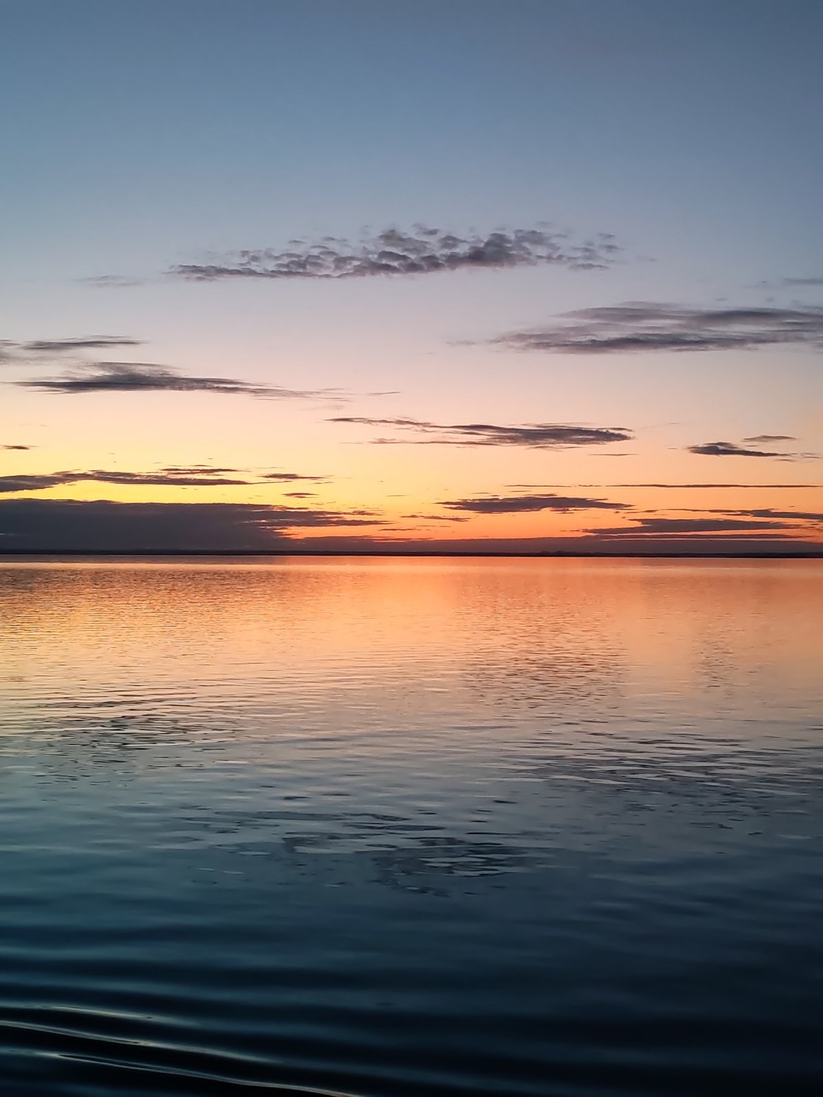 Maritime sunrise captured from cargo ship deck in Russia