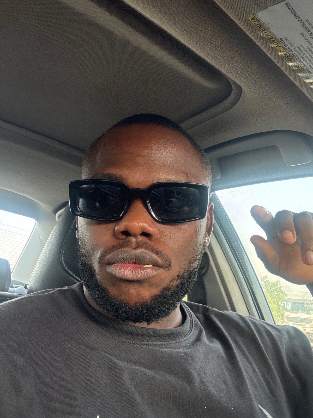 Car journey documented through selfies across Nigerian neighborhoods