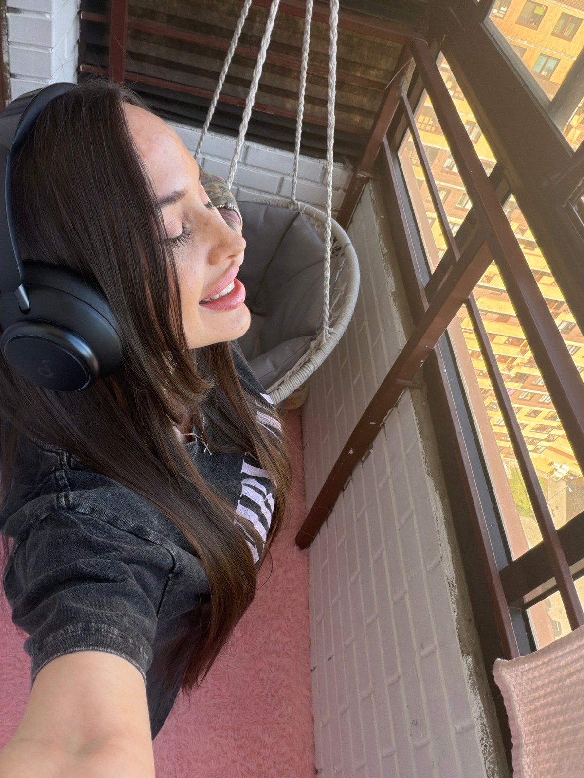 Woman enjoys music at home in Russian suburb