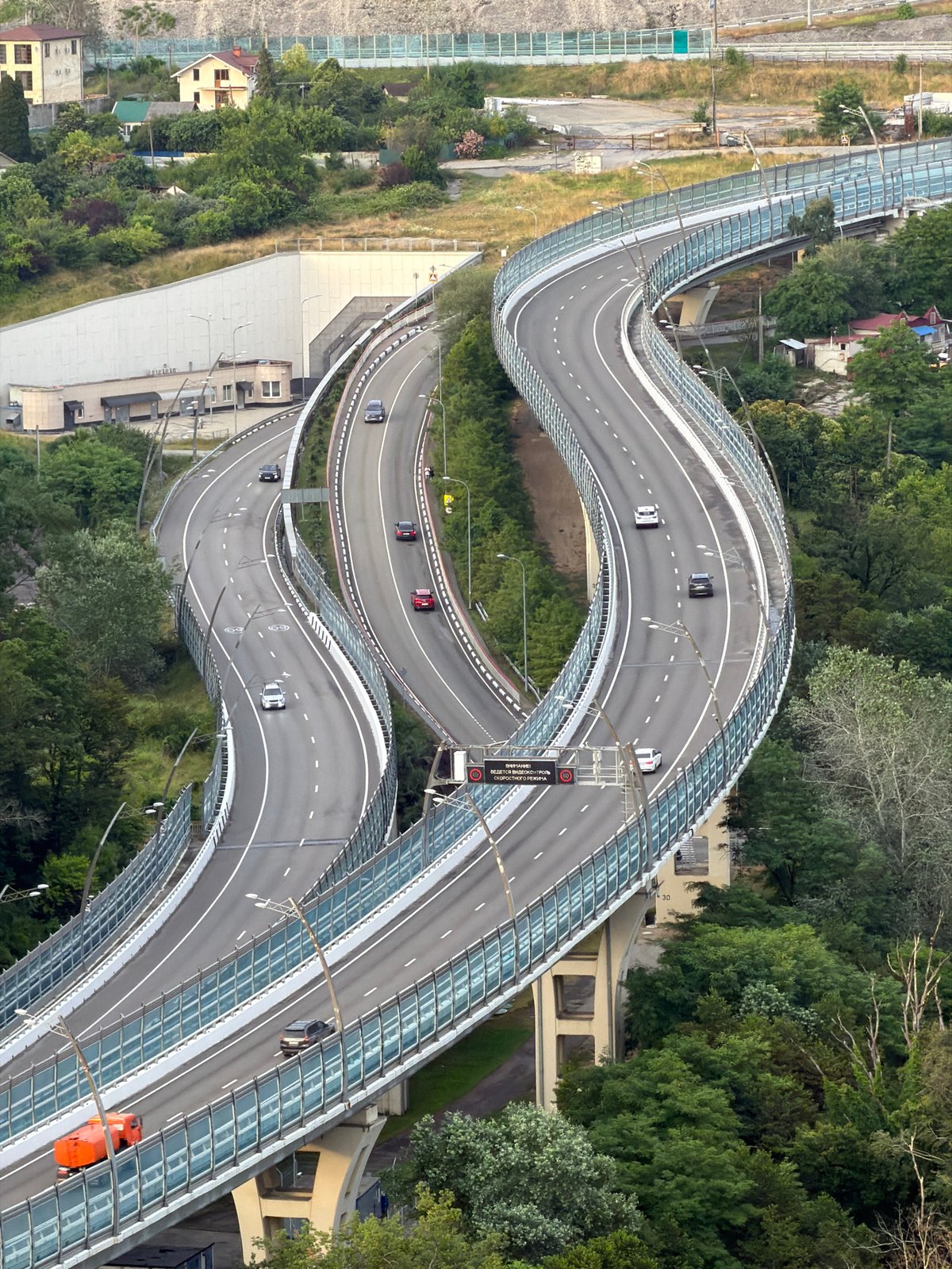 Sochi from multiple angles: highways, hillside housing, and Mount Akhun