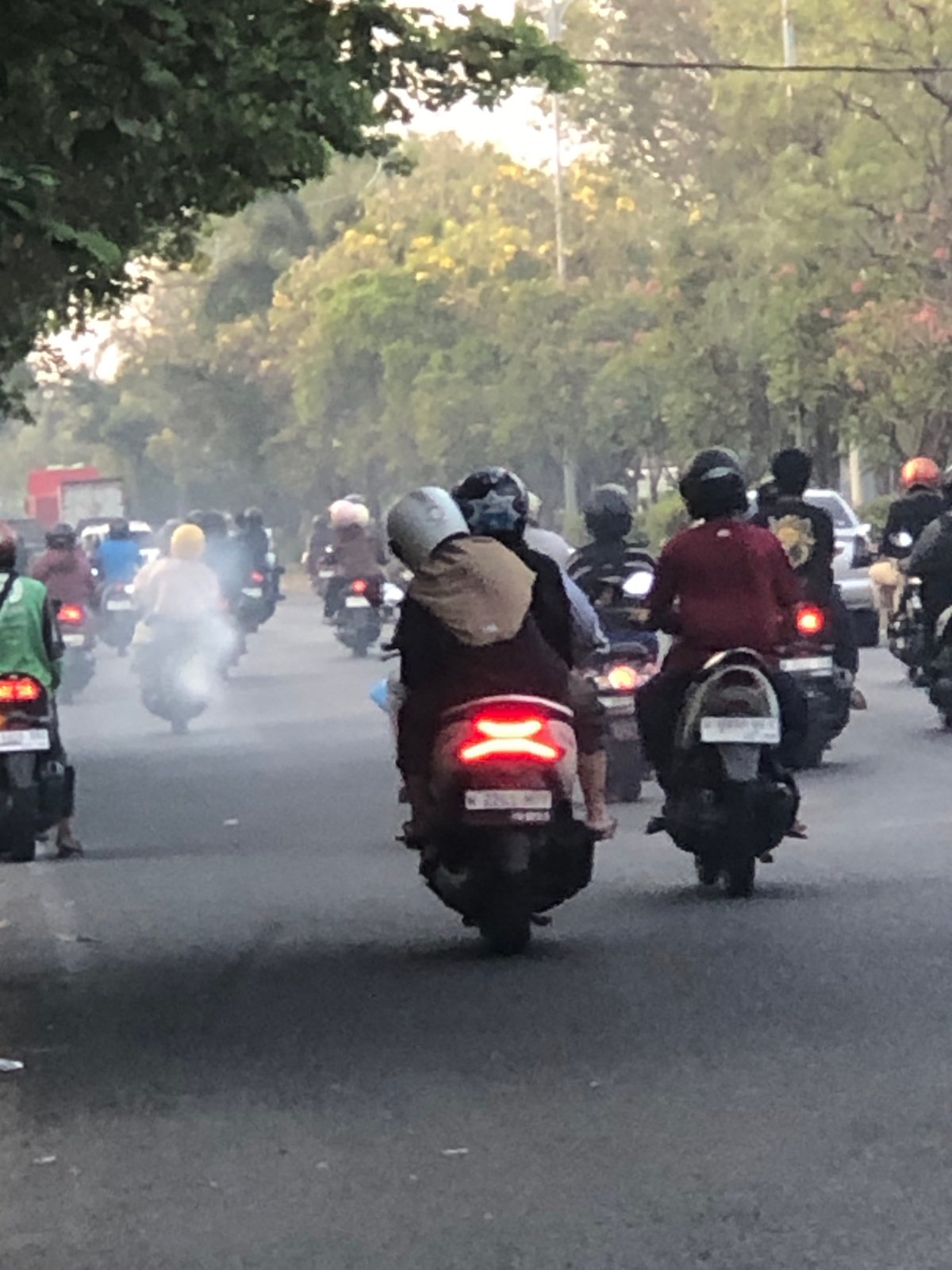 Heavy motorcycle and mixed traffic flows through Sumorame, Indonesia